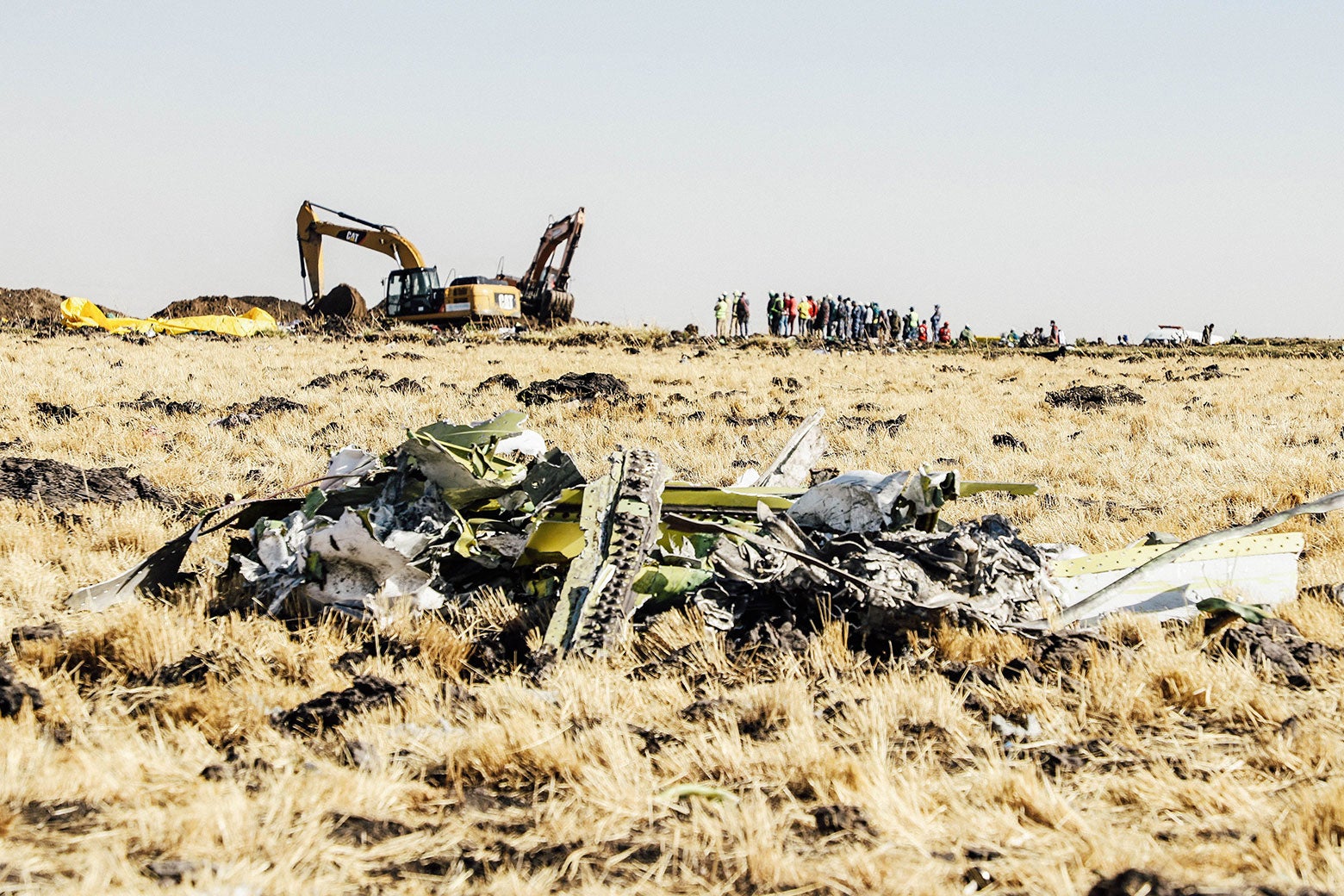 A power shovel digs next to debris at the Ethiopia Airlines' crash site.