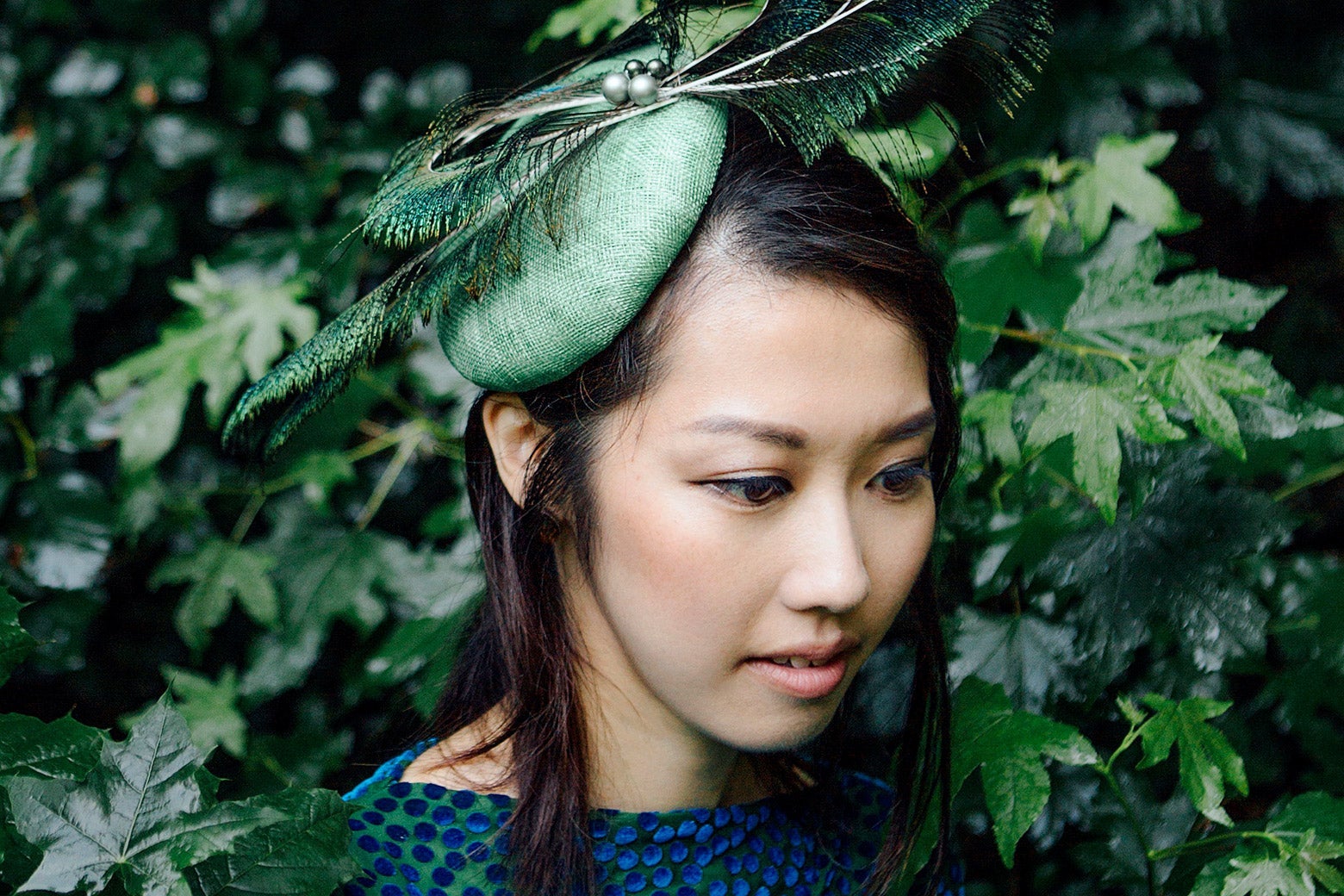 Miho Hazama against a backdrop of green leaves.