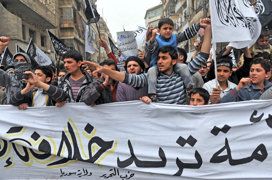 Syrian protesters wave Islamist flags as they march during an anti-regime demonstration in the northern city of Aleppo, Syria, on March 22, 2013.
