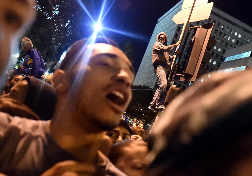 Protesters chant outside the Los Angeles police headquarters on Nov. 25, 2014, during demonstrations against a decision by a Ferguson, Missouri, grand jury not to indict a white police officer in the shooting of black teenager Michael Brown