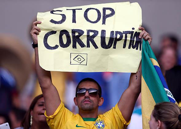 A fan holds up a sign reading "Stop Corruption" during the FIFA Confederations Cup Brazil.
