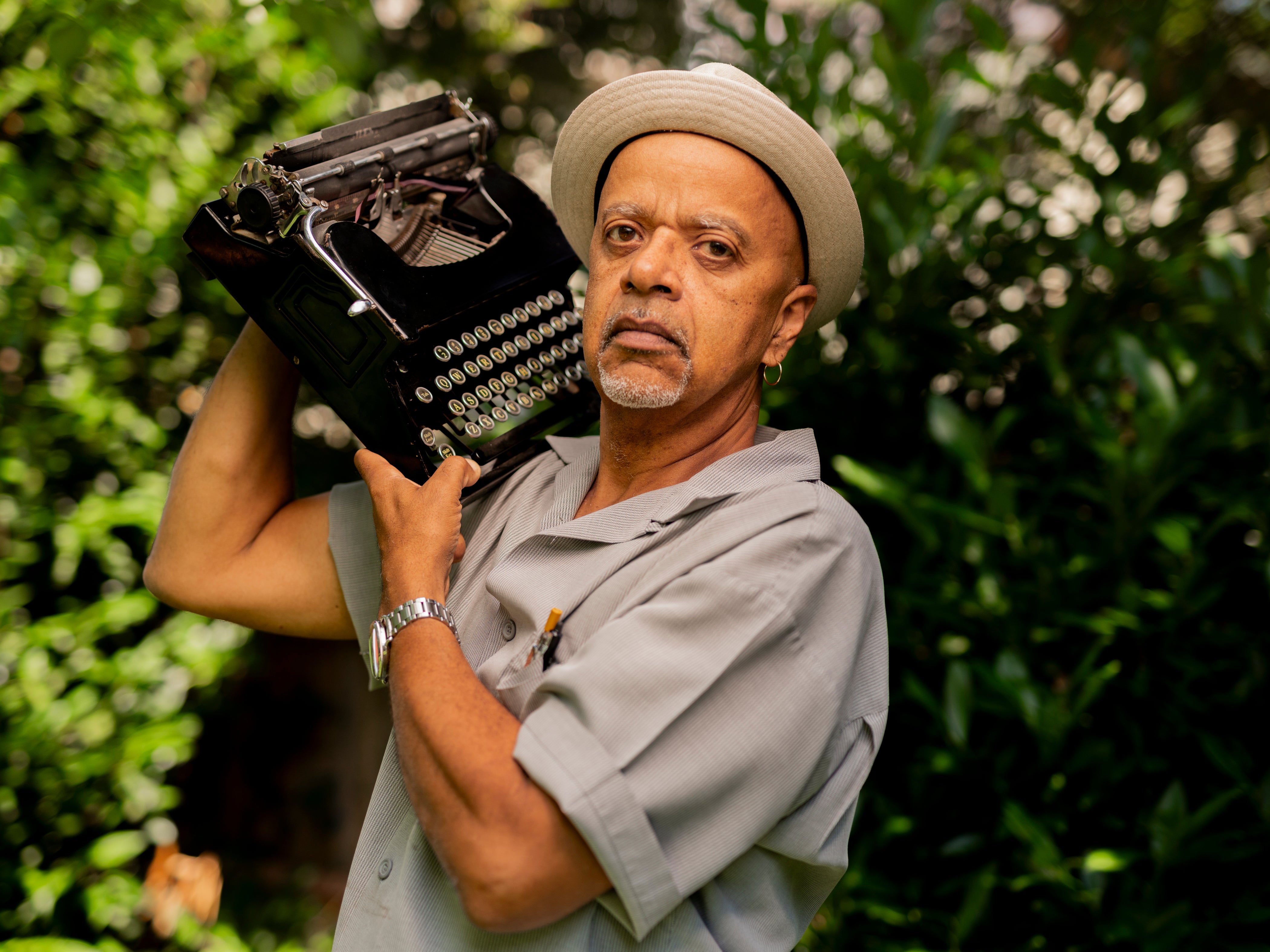 Portrait of James McBride holding a typewritter.