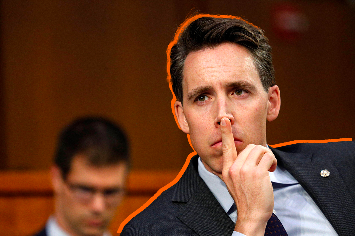 Josh Hawley holds the tip of his pointer finger to the tip of his nose in contemplation.