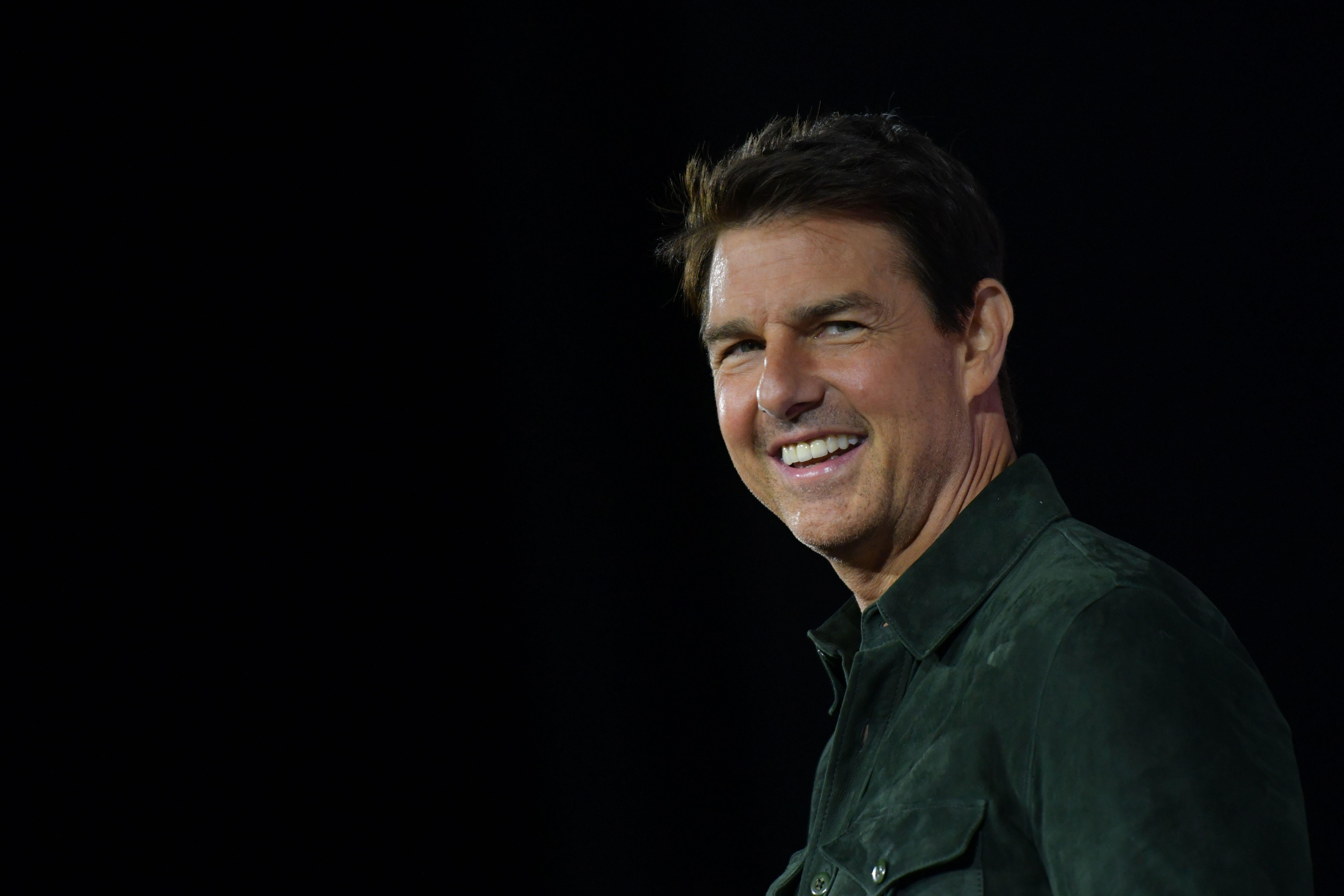 Actor Tom Cruise makes a surprise appearance in Hall H to promote Top Gun: Maverick  at the Convention Center during Comic Con in San Diego, California on July 18, 2019. (Photo by Chris Delmas / AFP)        (Photo credit should read CHRIS DELMAS/AFP/Getty Images)