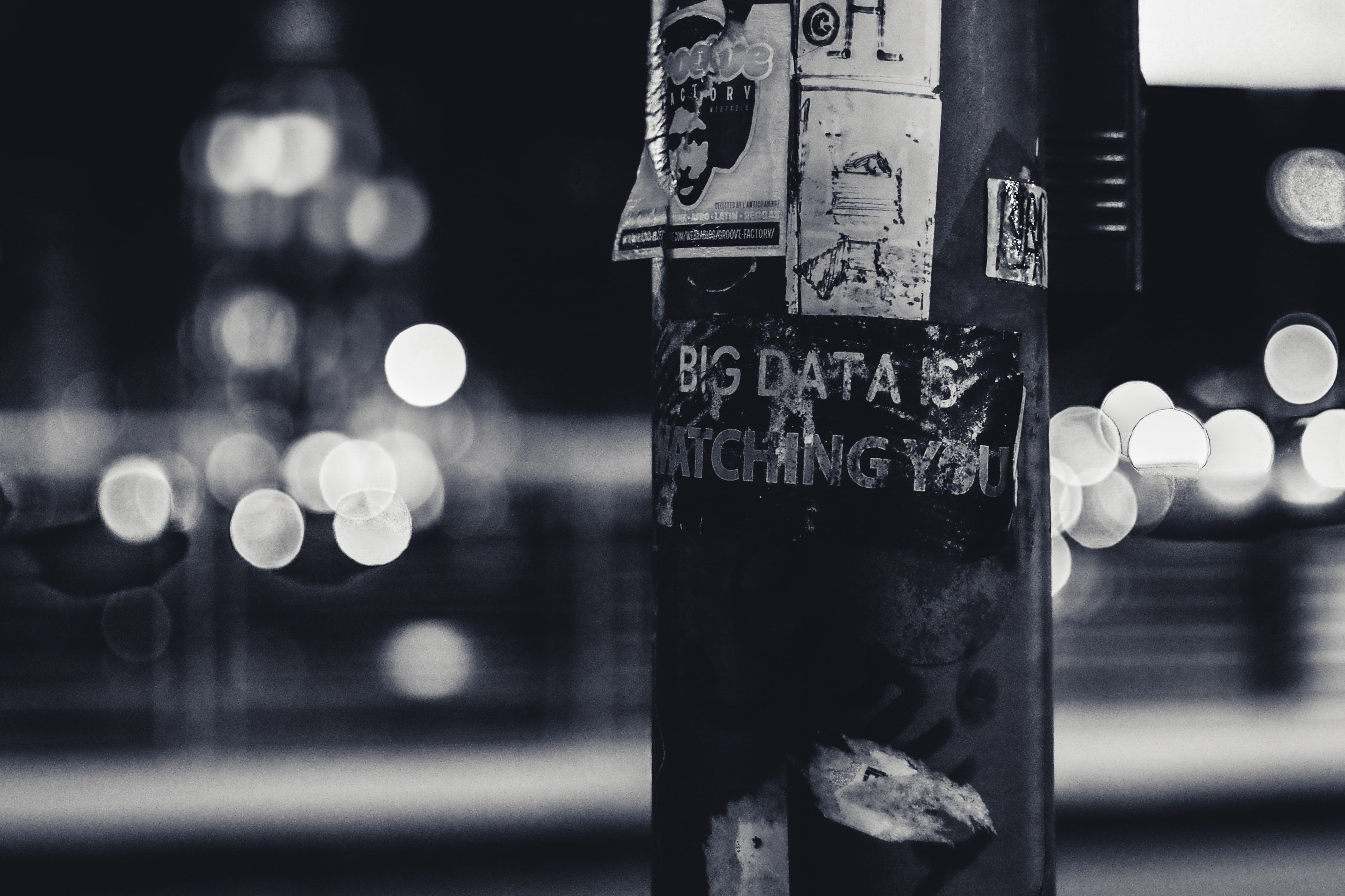A sticker on a lamppost says "Big data is watching you."