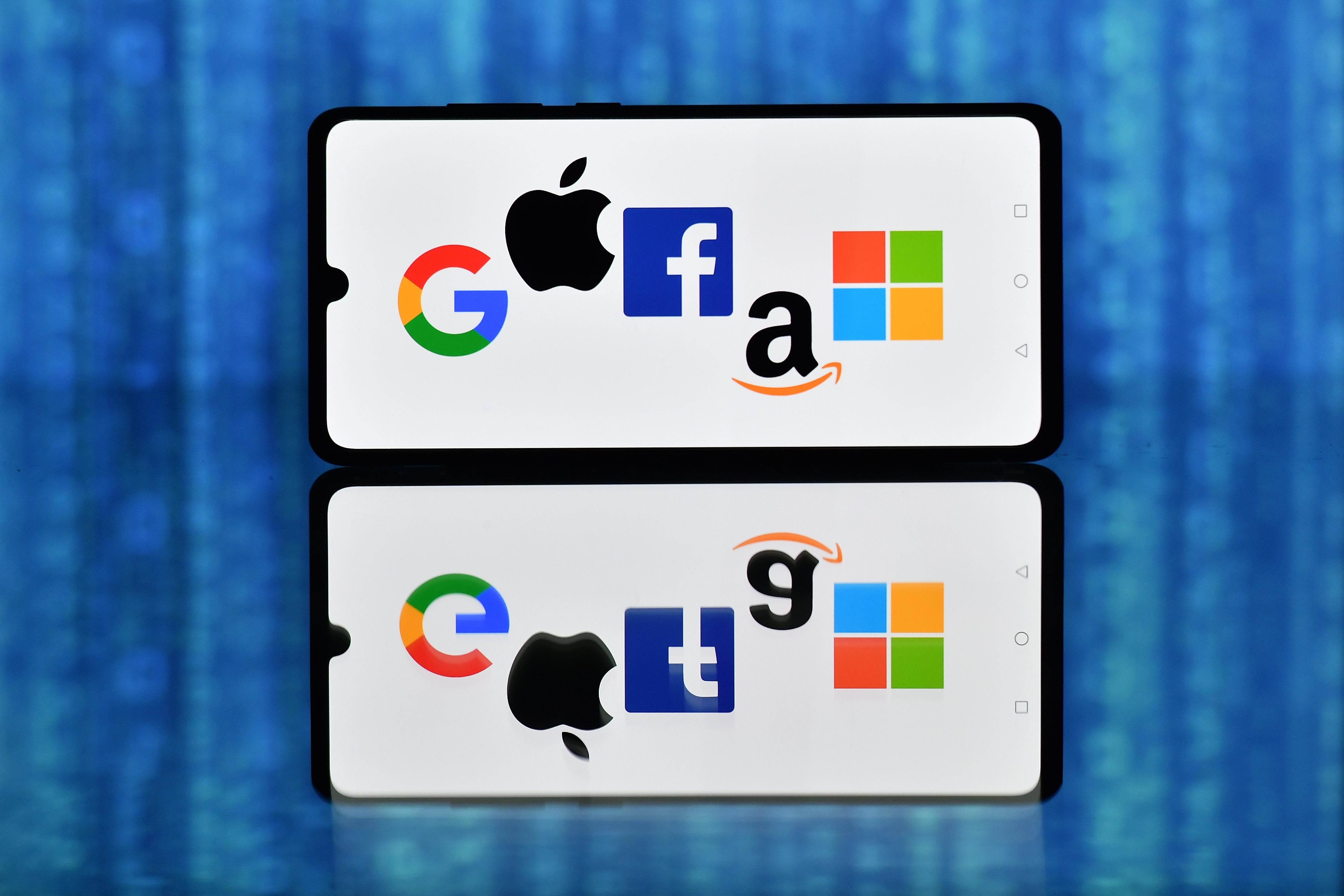 An illustration picture shows the logos of Google, Apple, Facebook, Amazon and Microsoft displayed on a mobile phone.