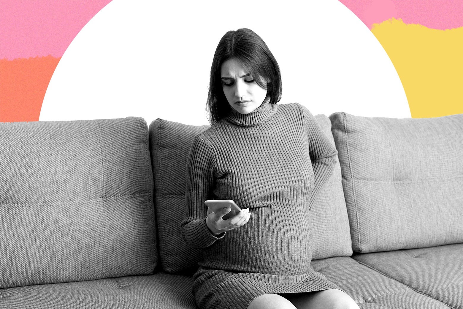 A pregnant woman looks annoyed at her phone.