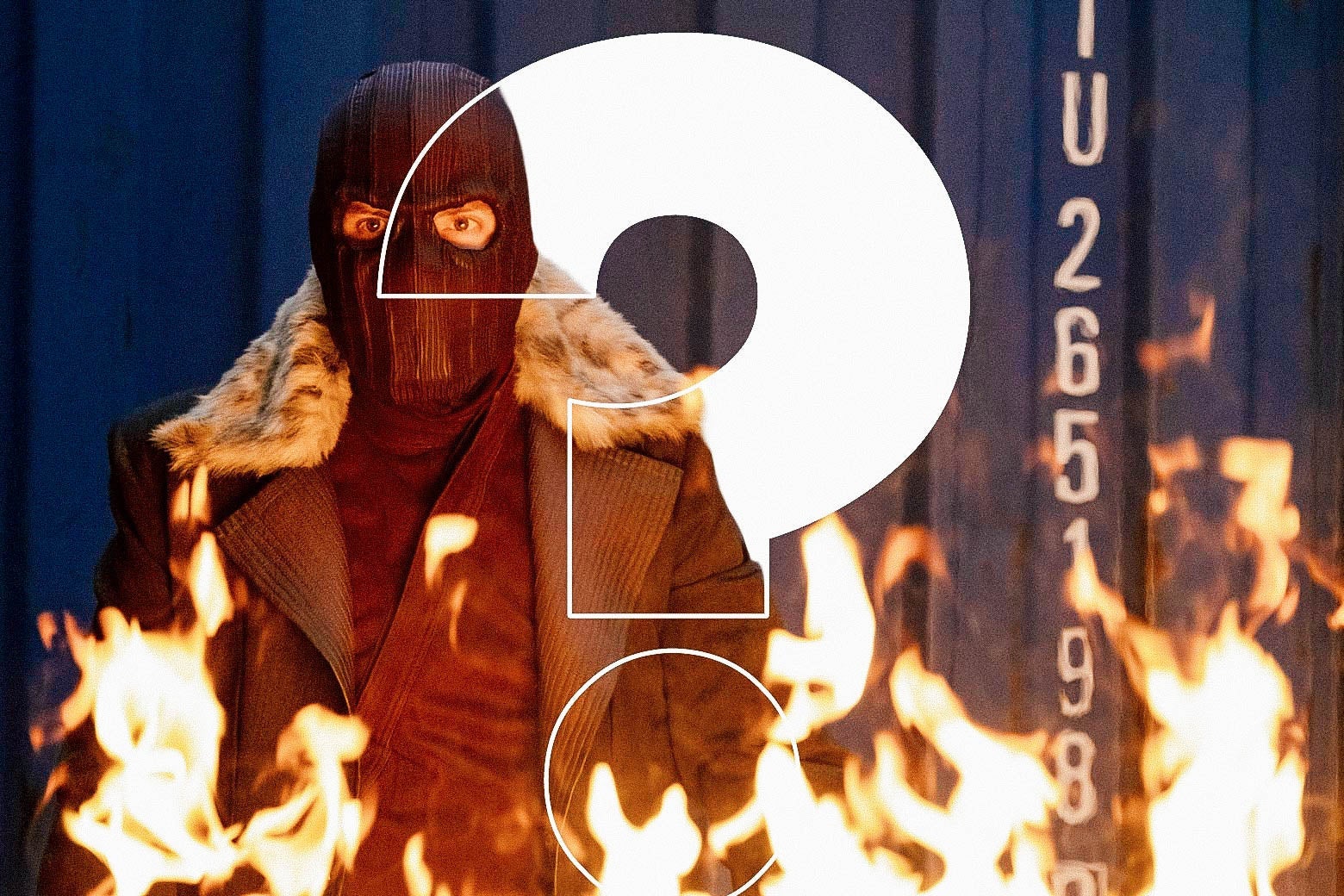 A masked white man in a heavy coat stands as a fire blazes in front of him. Over the image, a giant question mark.