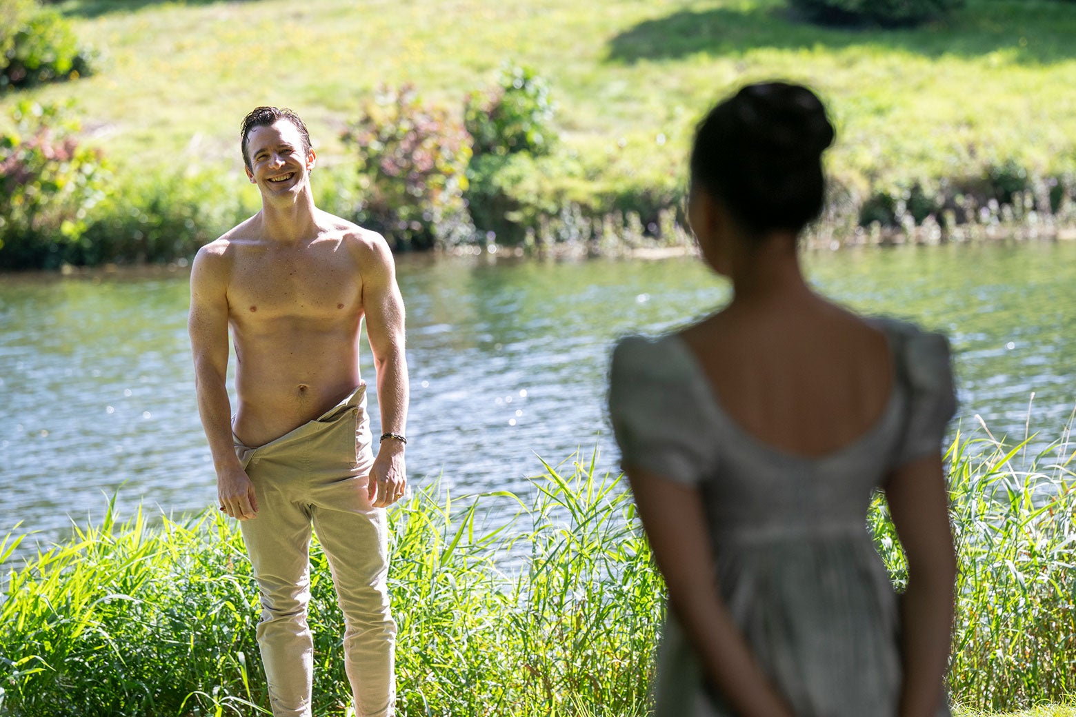 Benedict, shirtless by a river, facing Sophie.