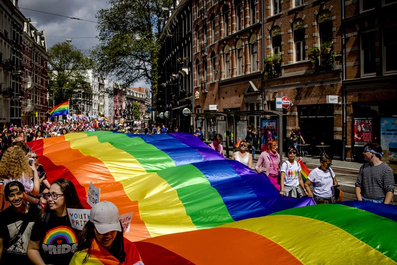 People hold a large rainbow flag during the Pride Walk through the center of Amsterdam on July 29, 2017. 
The march marks the beginning of Pride Amsterdam, a festival to raise awareness of LGBT rights. / AFP PHOTO / ANP / Sander Koning / Netherlands OUT        (Photo credit should read SANDER KONING/AFP/Getty Images)