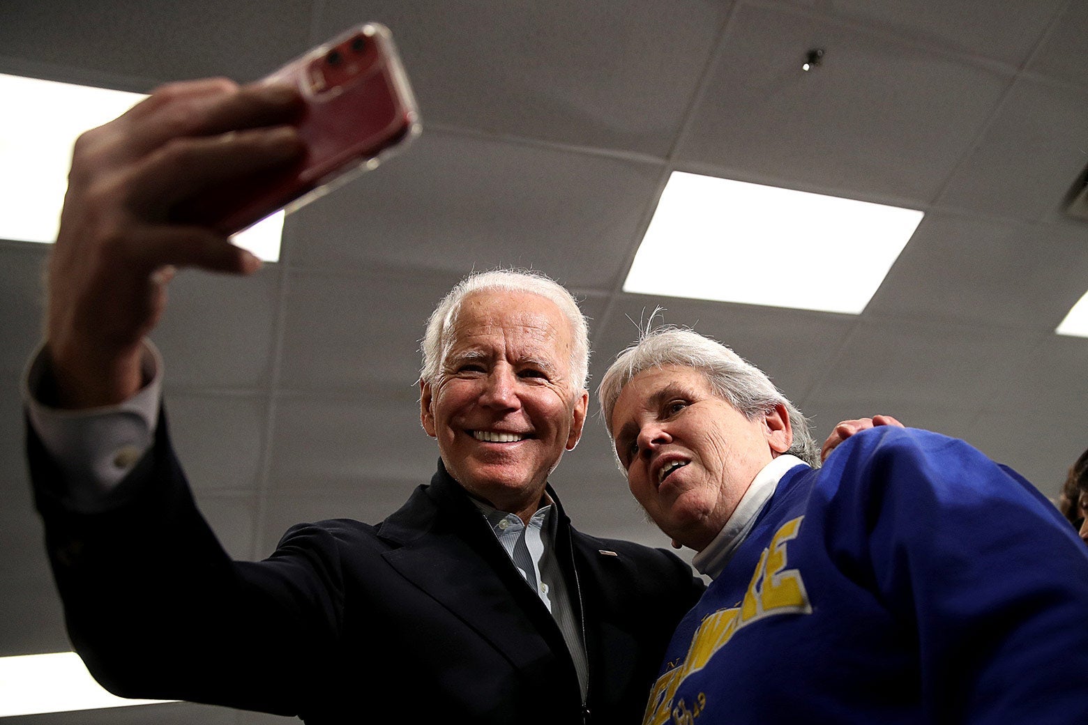 Biden takes a selfie with an older woman, both smiling