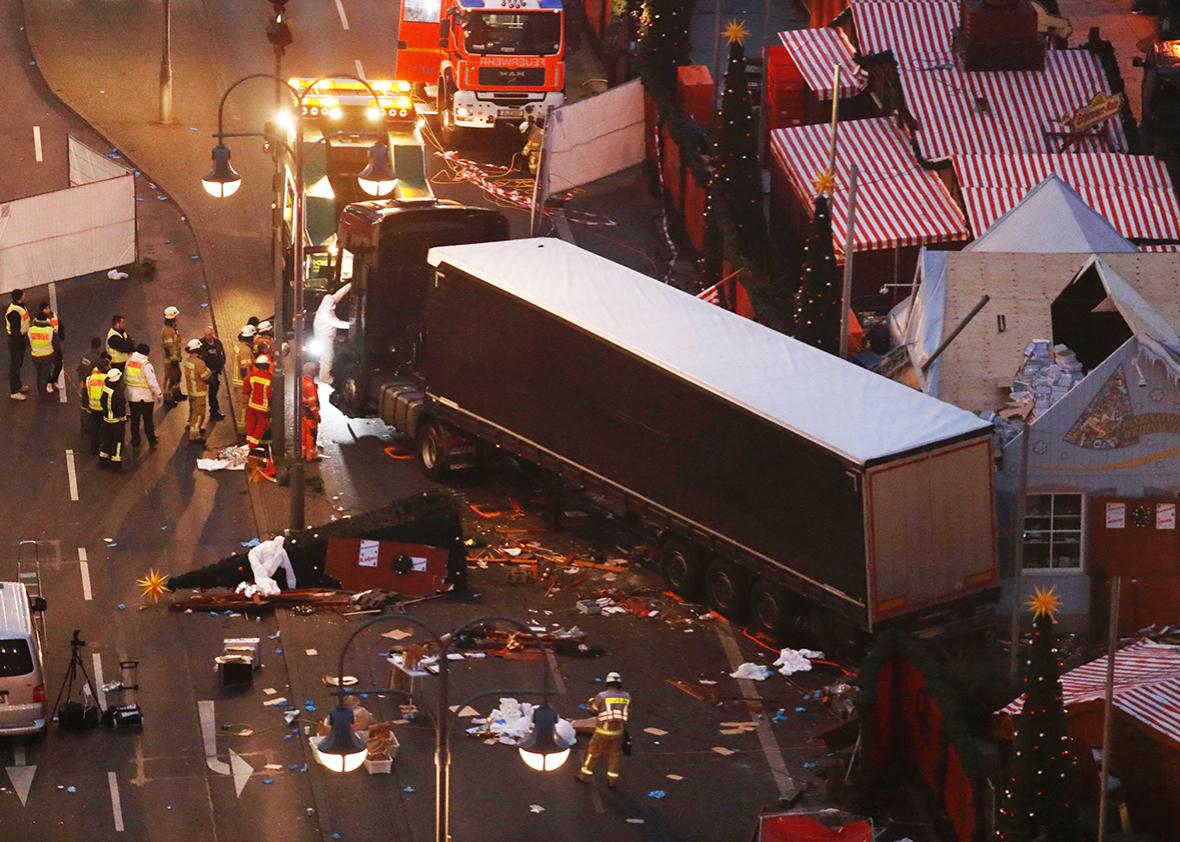 Forensic experts examine the scene around a truck that crashed into a Christmas market on December 20, 2016 in Berlin.