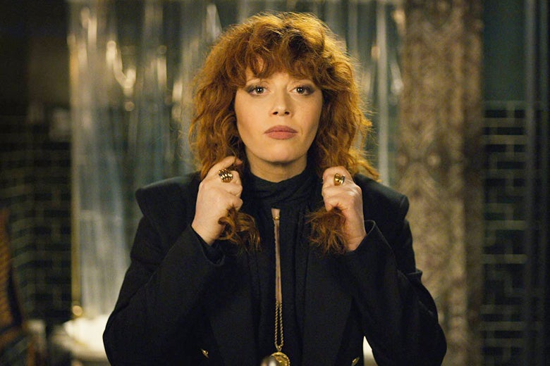 Still from Russian Doll: Nadia, played by Natasha Lyonne, grabs fistfuls of her long red hair.