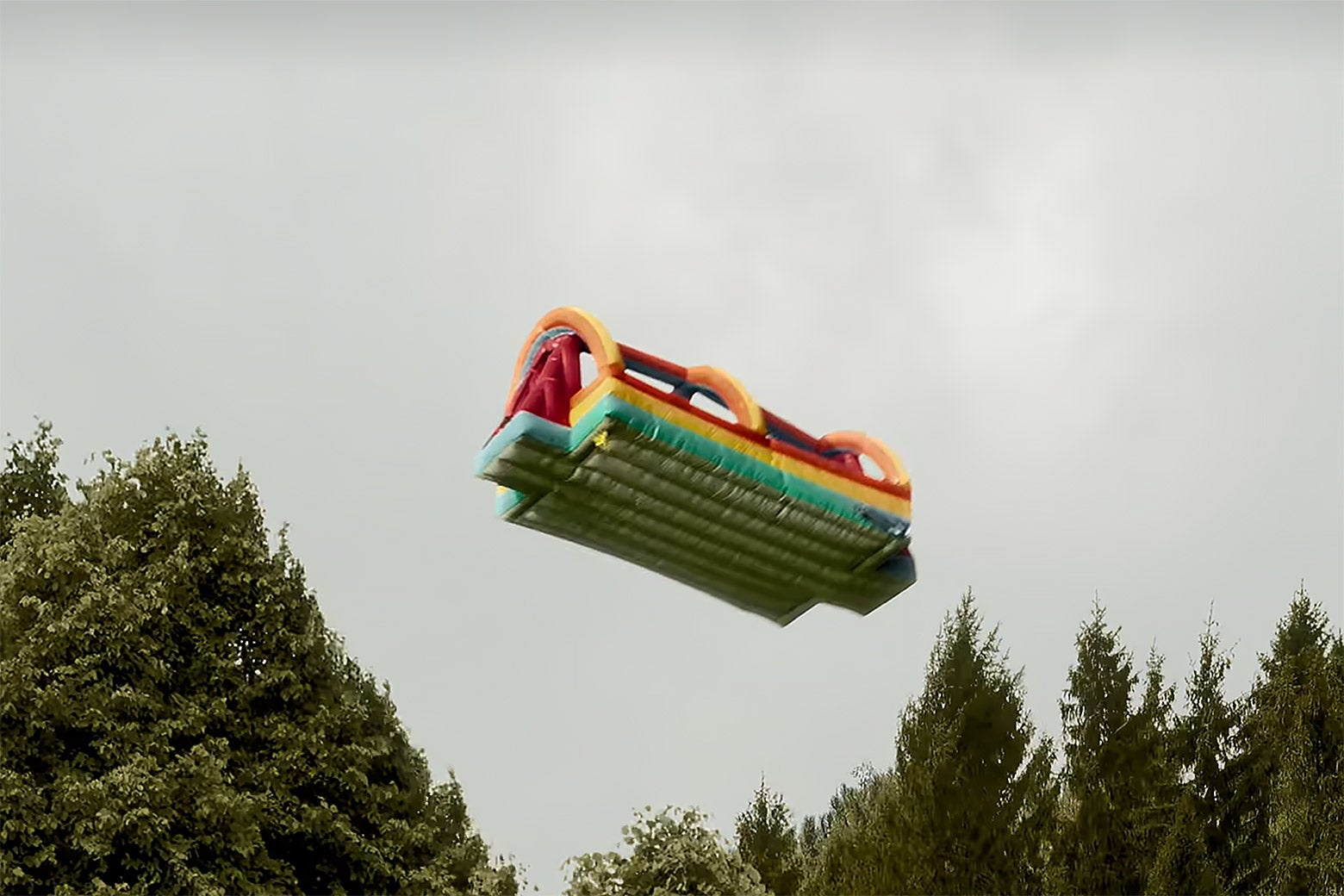 A bounce house flying in midair.