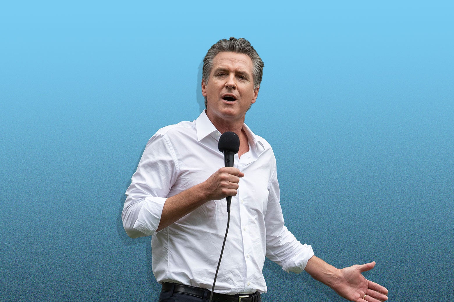 Politics tamfitronics Gavin Newsom with his collar open and sleeves rolled up talking into a mic.