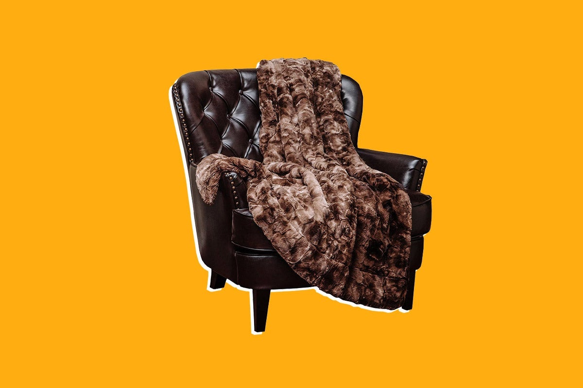 A faux fur blanket on a chair