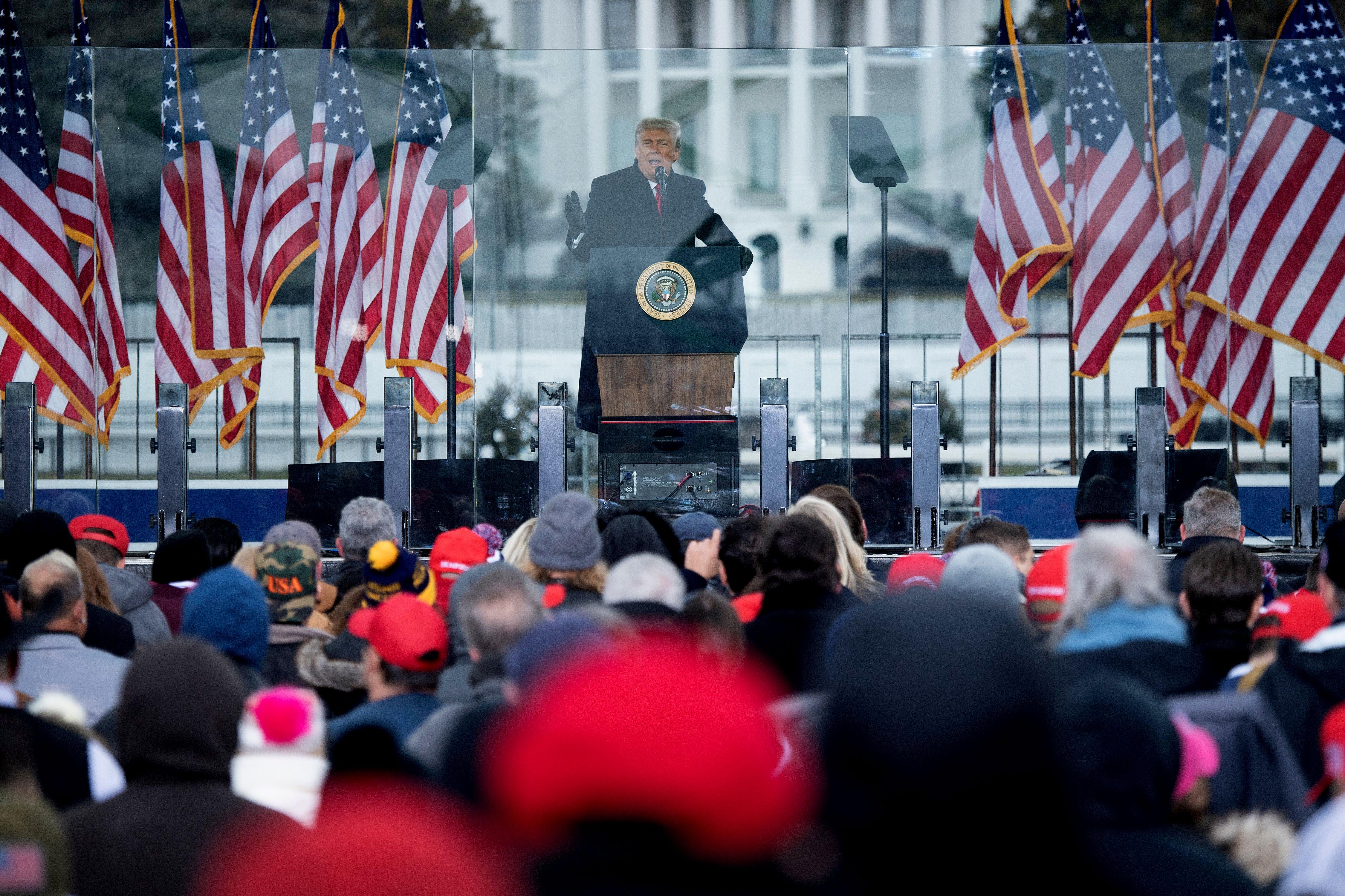 Trump in front of the White House with a small crowd.