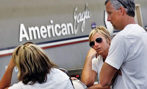 American Airlines customer rests her head on the counter.