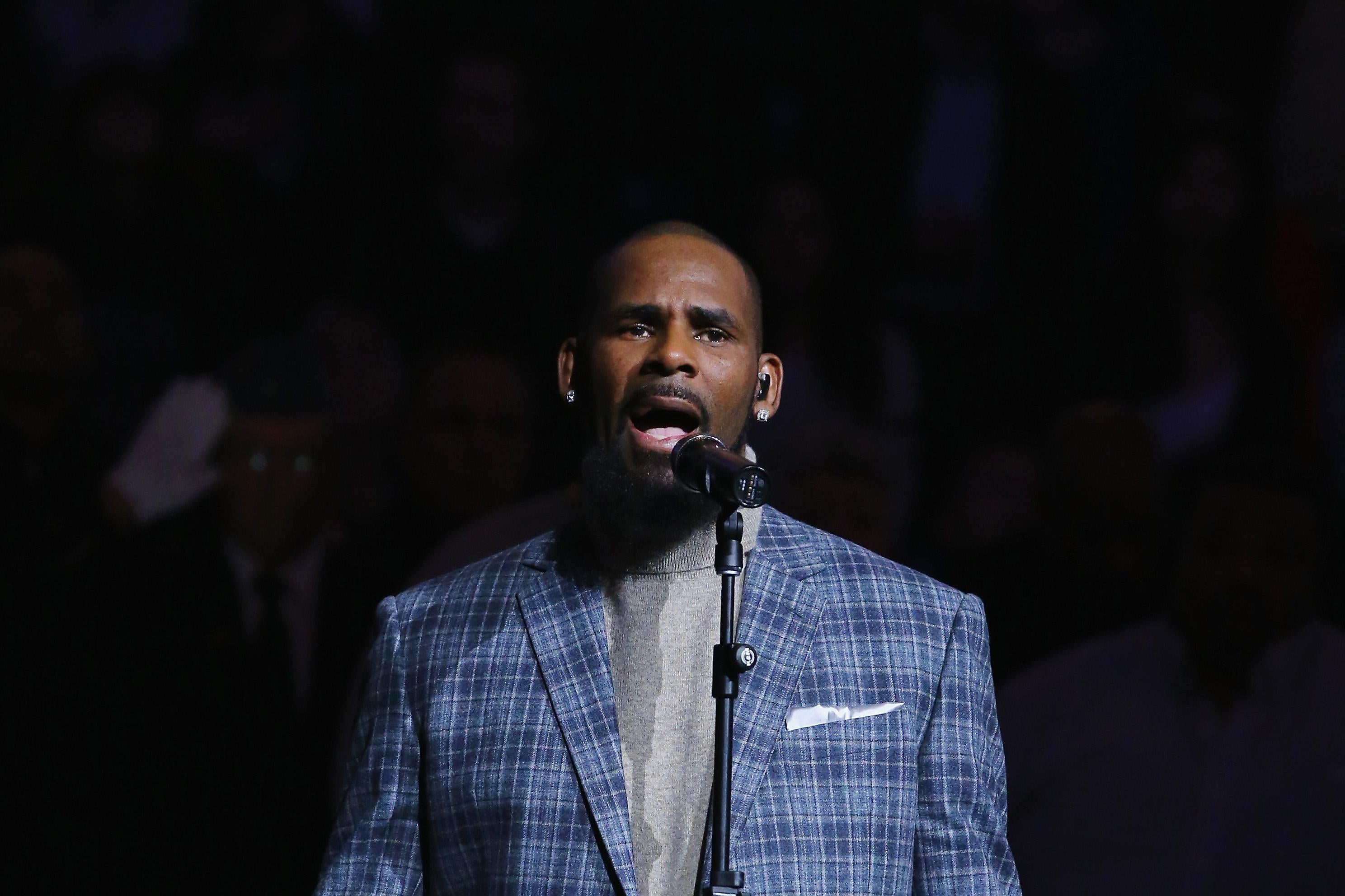 Singer R. Kelly sings the National anthem before the Brooklyn Nets vs the Atlanta Hawks  at The Barclays Center on November 17, 2015 in New York City.   NOTE TO USER: User expressly acknowledges and agrees that, by downloading and or using this photograph, User is consenting to the terms and conditions of the Getty Images License Agreement.
