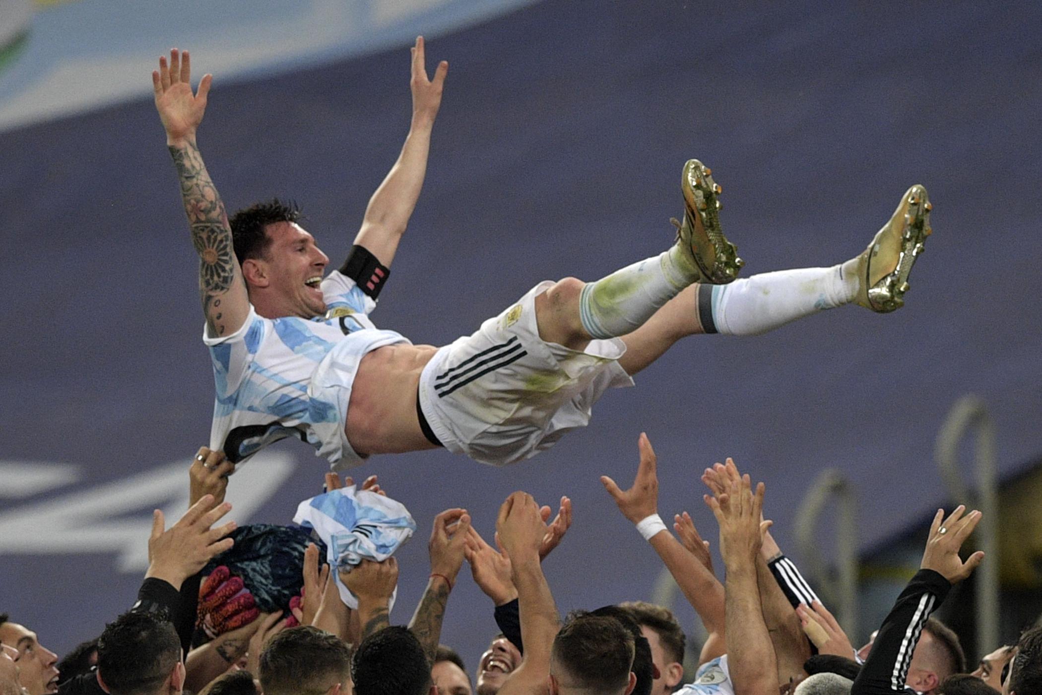 Argentina's Lionel Messi is thrown into the air by teammates after winning the Conmebol 2021 Copa America football tournament final match against Brazil at Maracana Stadium in Rio de Janeiro, Brazil, on July 10, 2021. 