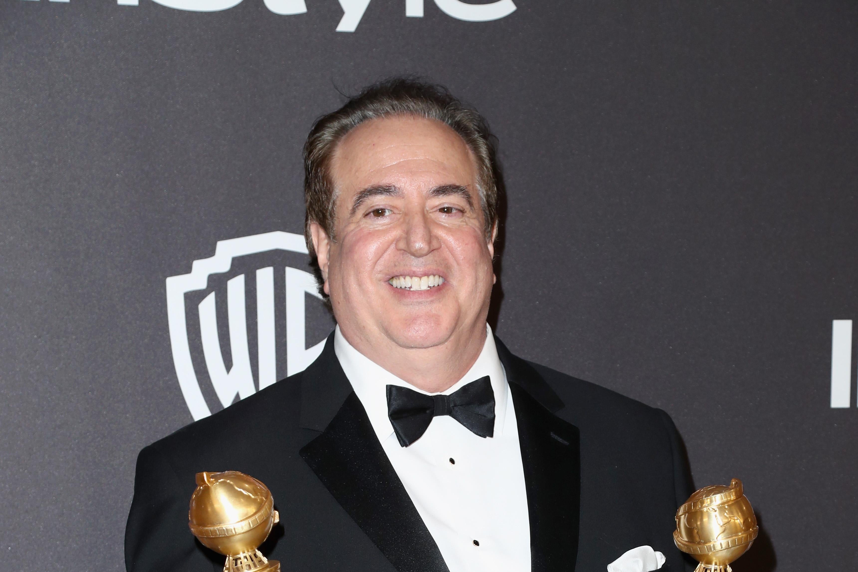 Nick Vallelonga holding his Golden Globes.