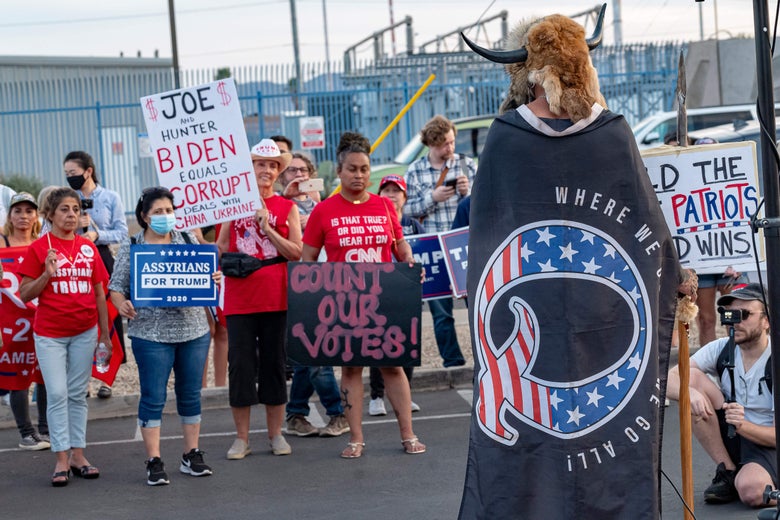 A supporter wrapped QAnon flag at a pro-Trump rally in Arizona.