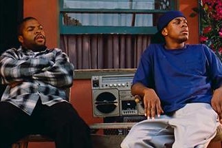Ice Cube and Chris Tucker sit on chairs in Friday.