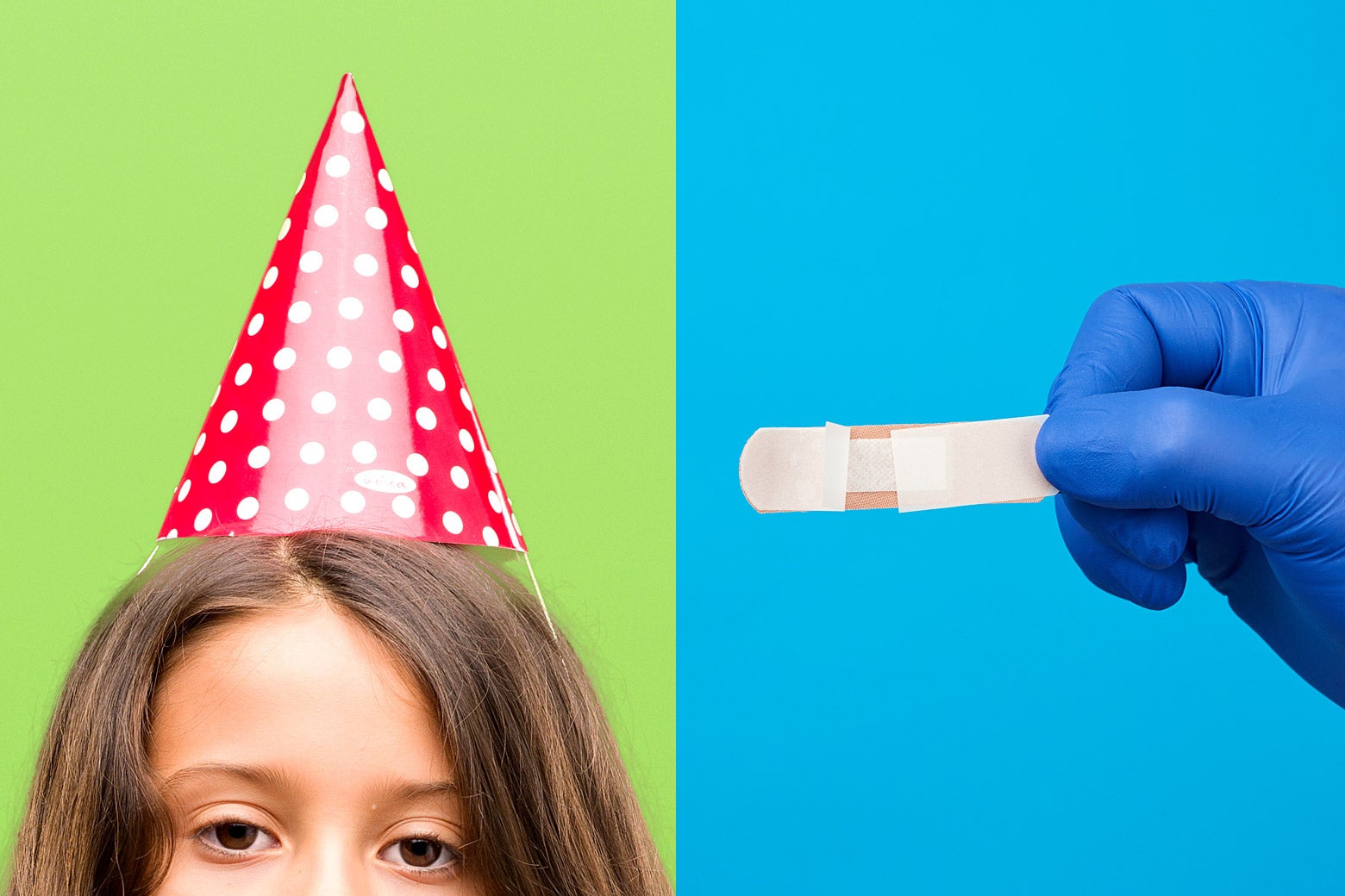 A child in a birthday hat and a gloved hand holding a band-aid.
