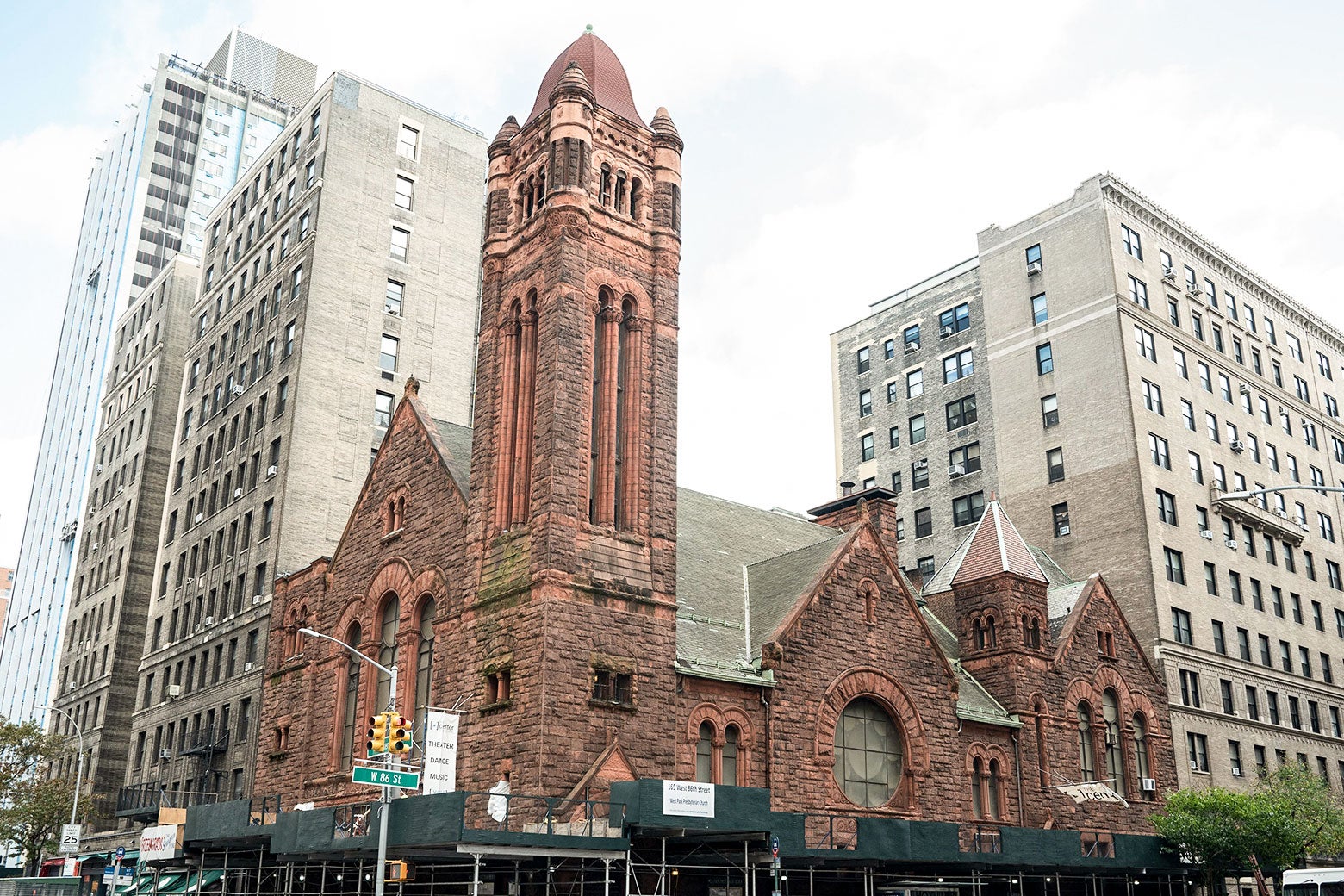 A view of the West Park Presbyterian Church in Manhattan, surrounded on either side by much taller buildings.