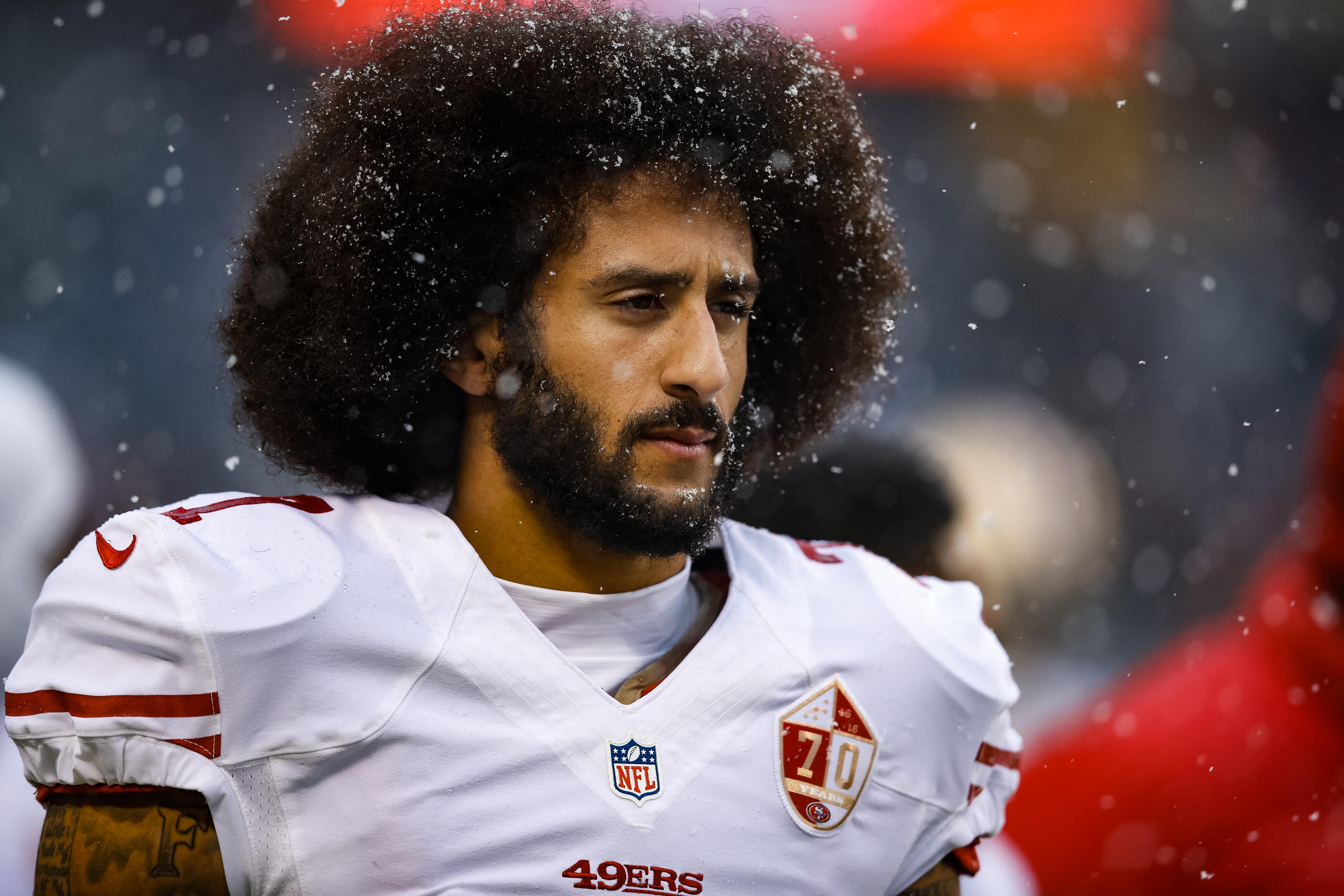 Colin Kaepernick in his San Francisco 49ers uniform, with snow falling around him.