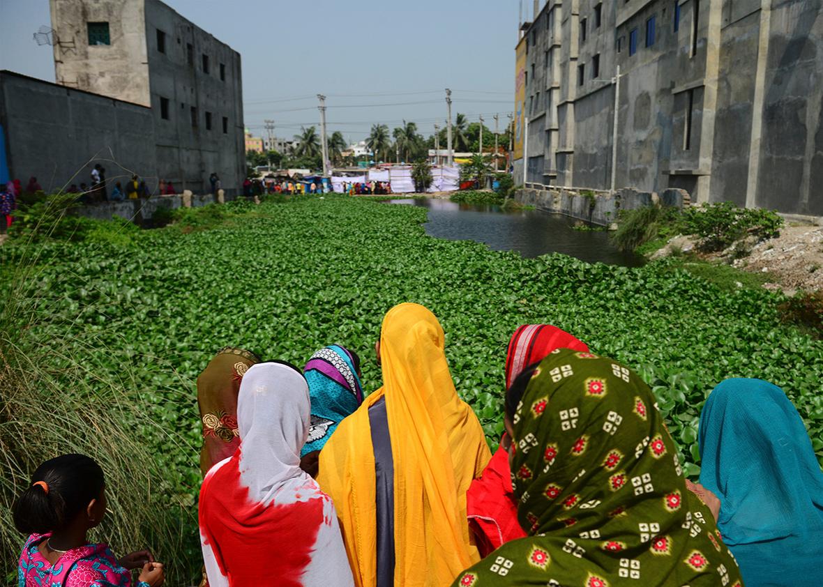 Bangladeshi onlookers gather at the site of the Rana Plaza building collapse on the third anniversary of the disaster in Savar, on the outskirts of Dhaka on April 24, 2016.