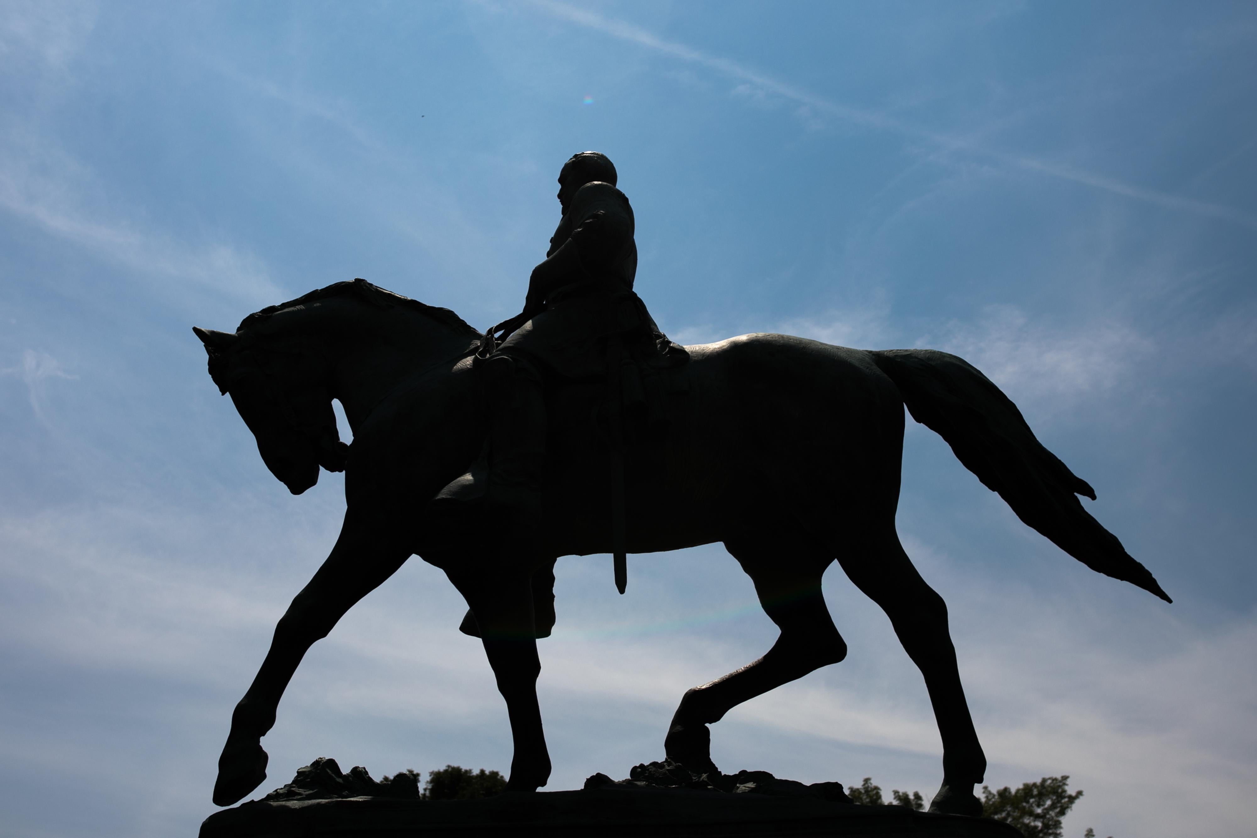 The statue of Robert E Lee on horseback is seen on a bright, sunny day.