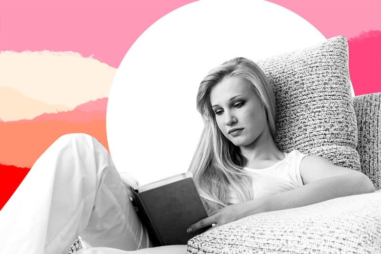 Teenage girl on a couch reading a book.