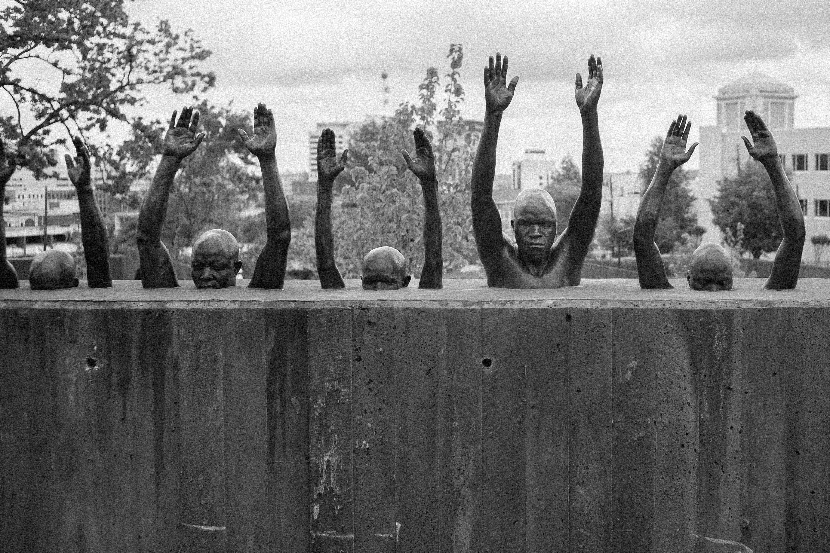 A sculpture, titled “Raise Up,” that is meant to echo the “hands up, don’t shoot” motion of Black Lives Matter protests.