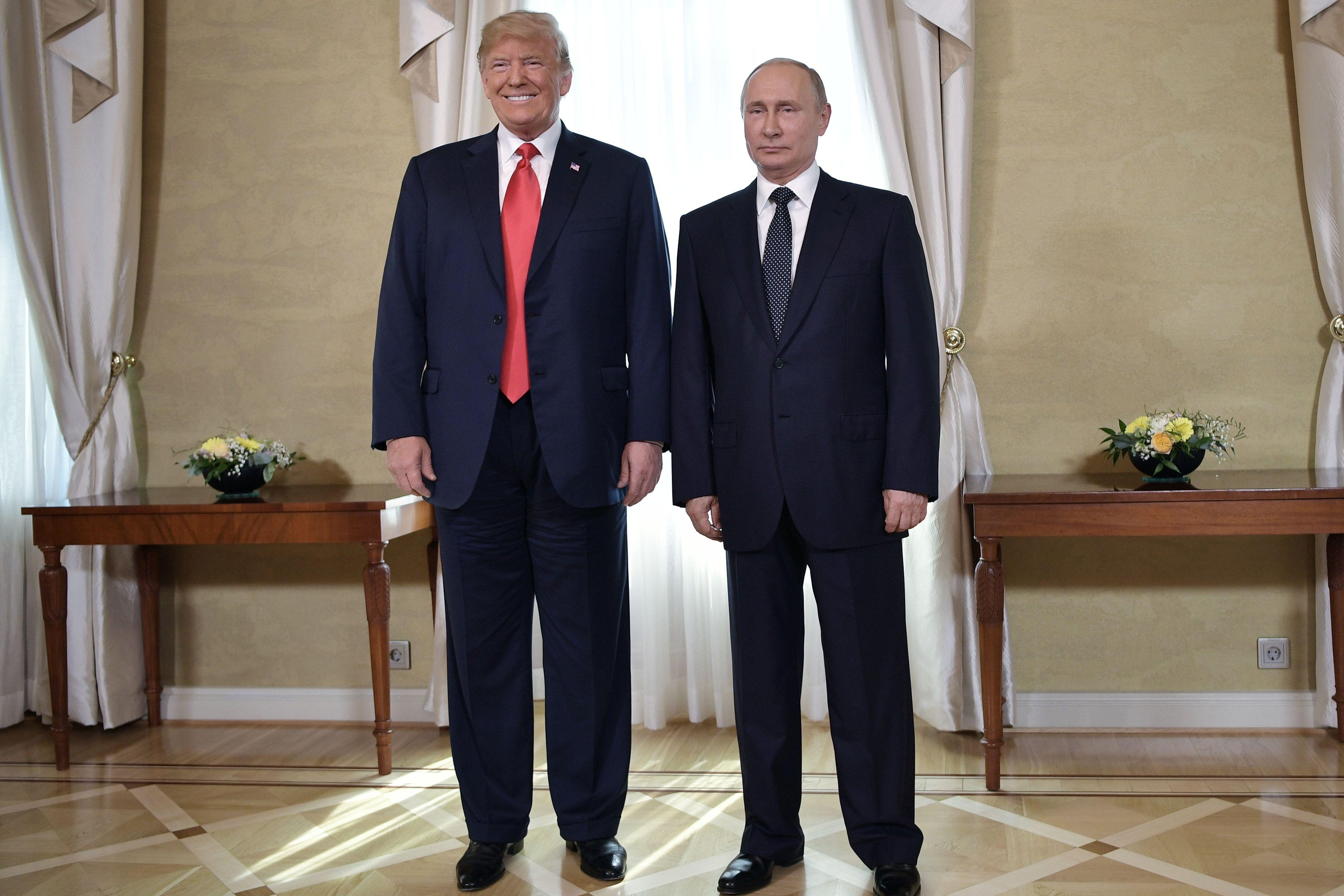 President Donald Trump and Russia's President Vladimir Putin pose ahead a meeting in Helsinki, on July 16, 2018.