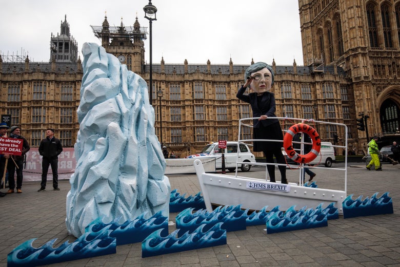 A demonstration featuring a papier-mâché Theresa May head sailing toward an iceberg outside the Houses of Parliament.