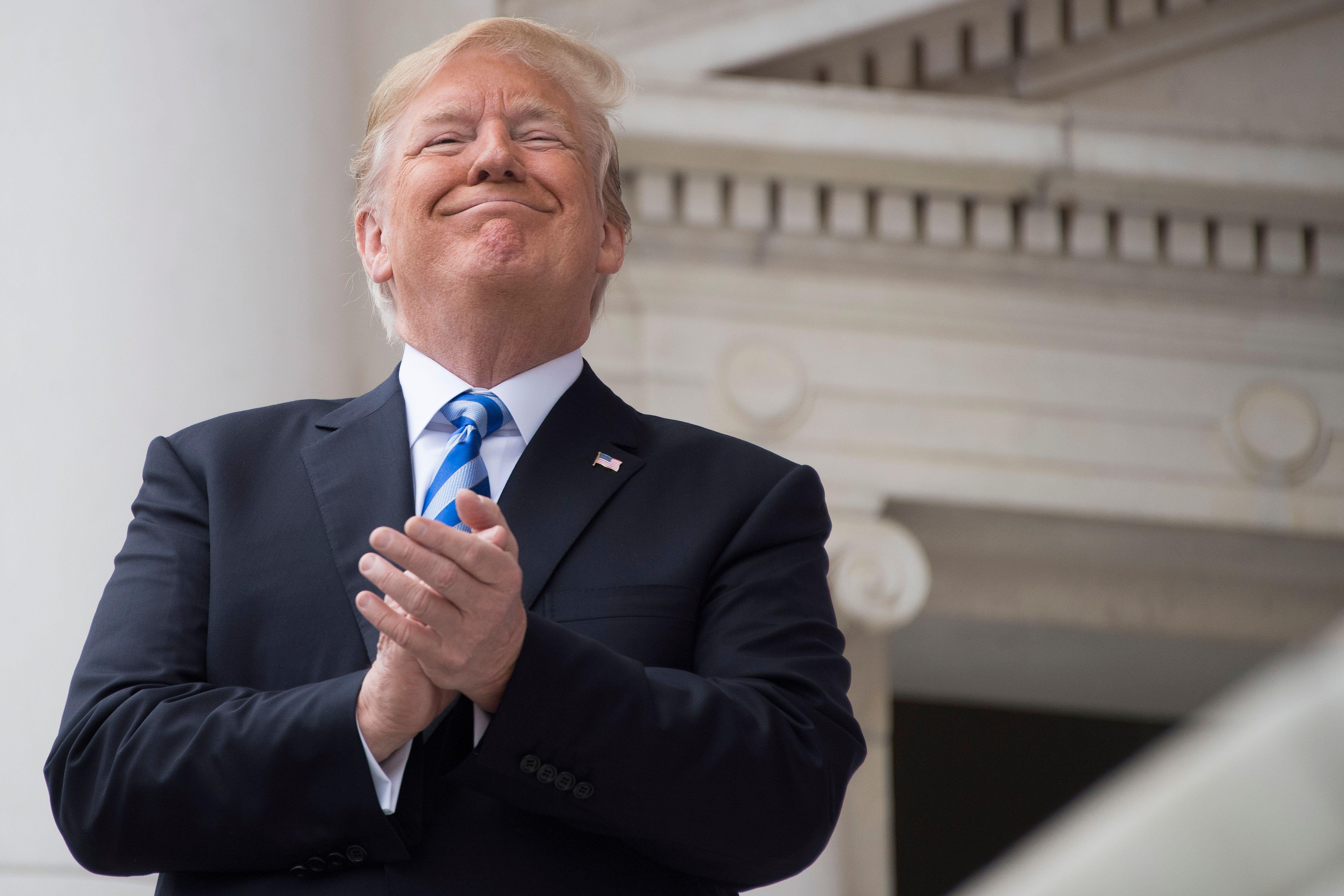 President Donald Trump applauds while speaking at a Memorial Day ceremony at Arlington National Cemetery in Arlington, Virginia, on May 28, 2018. 