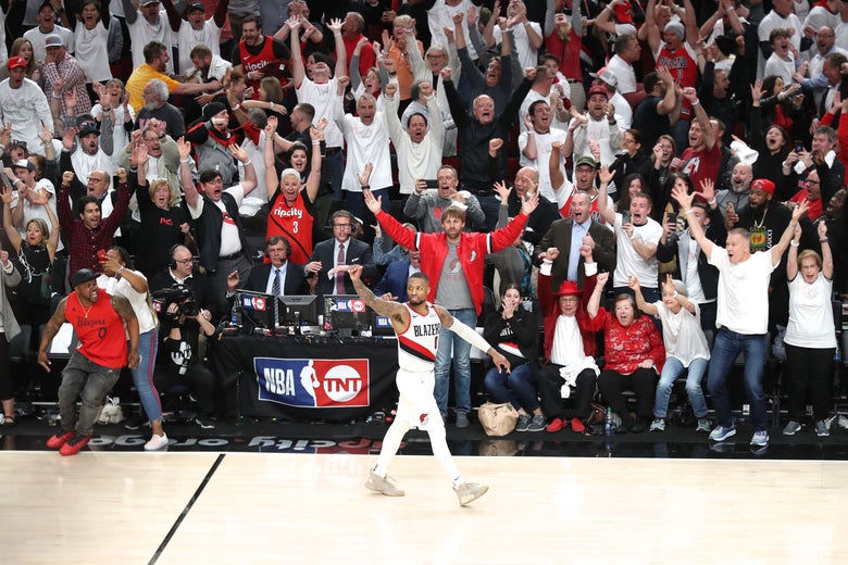 Lillard calmly waves toward Westbrook while walking away from the spot of his shot.