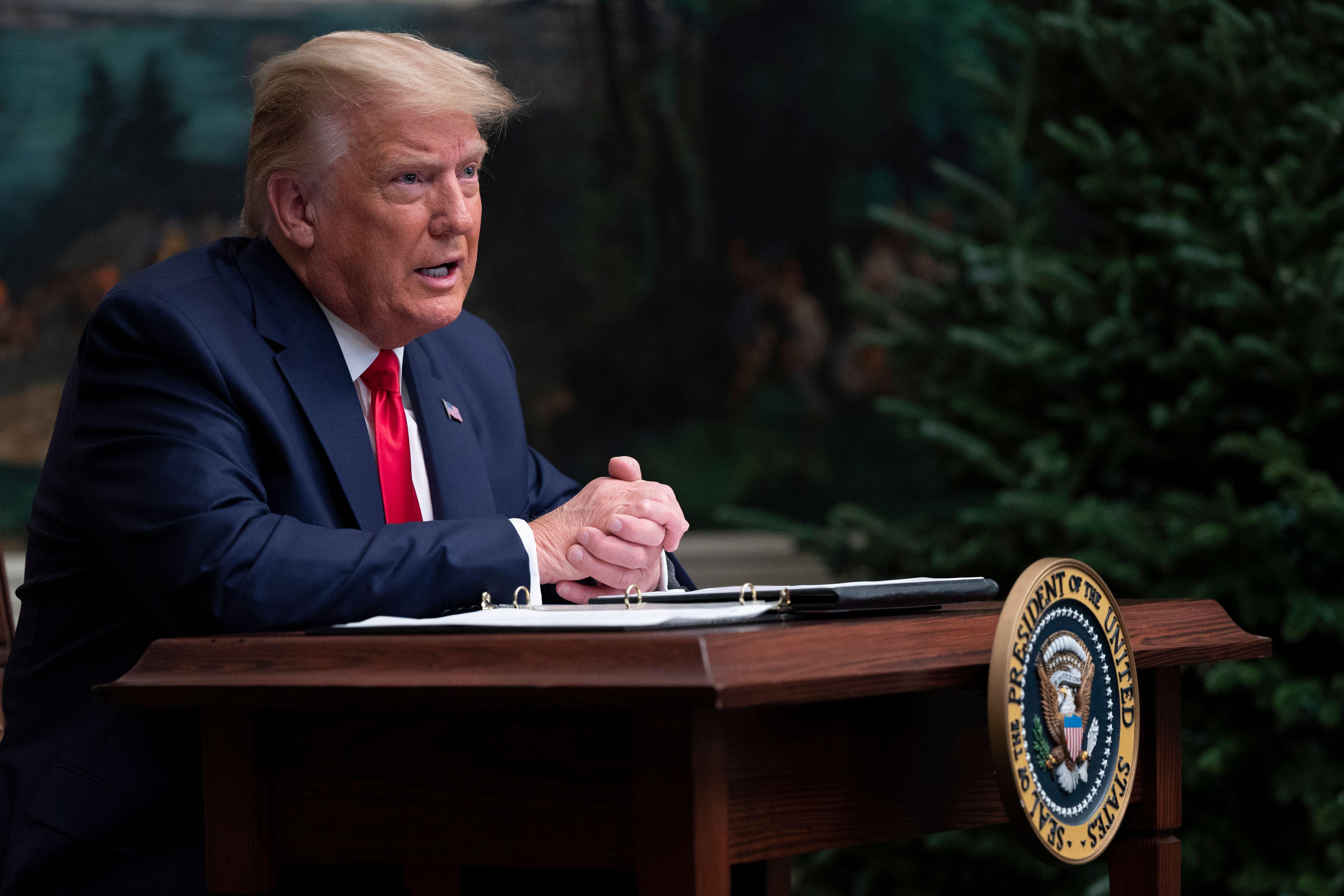 President Donald Trump speaks to reporters after participating in a Thanksgiving teleconference with members of the United States Military, at the White House in Washington, DC, on November 26, 2020. 