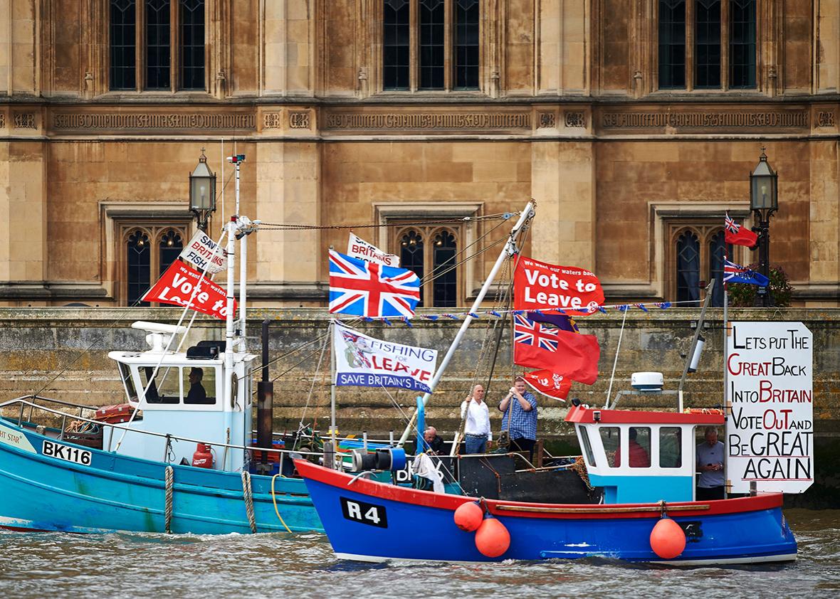 Boats decorated with flags and banners from the 'Fishing for Leave' group that are campaigning for a 'leave' vote in the EU referendum sail by the British Houses of Parliament as part of a "Brexit flotilla' on the river Thames in London on June 15, 2016.