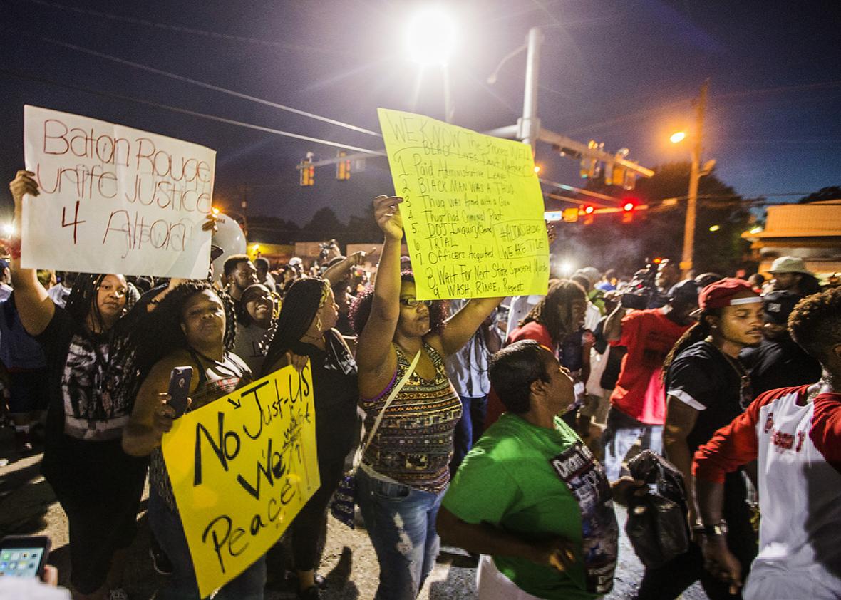 Protesters march to the convenience store where Alton Sterling was shot and killed, July 6, 2016 in Baton Rouge, Louisiana.  