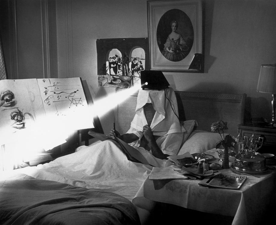 Spain. Salvador Dali in bed in 1964, projecting pieces of dirty paper "to stimulate his inspiration.”
