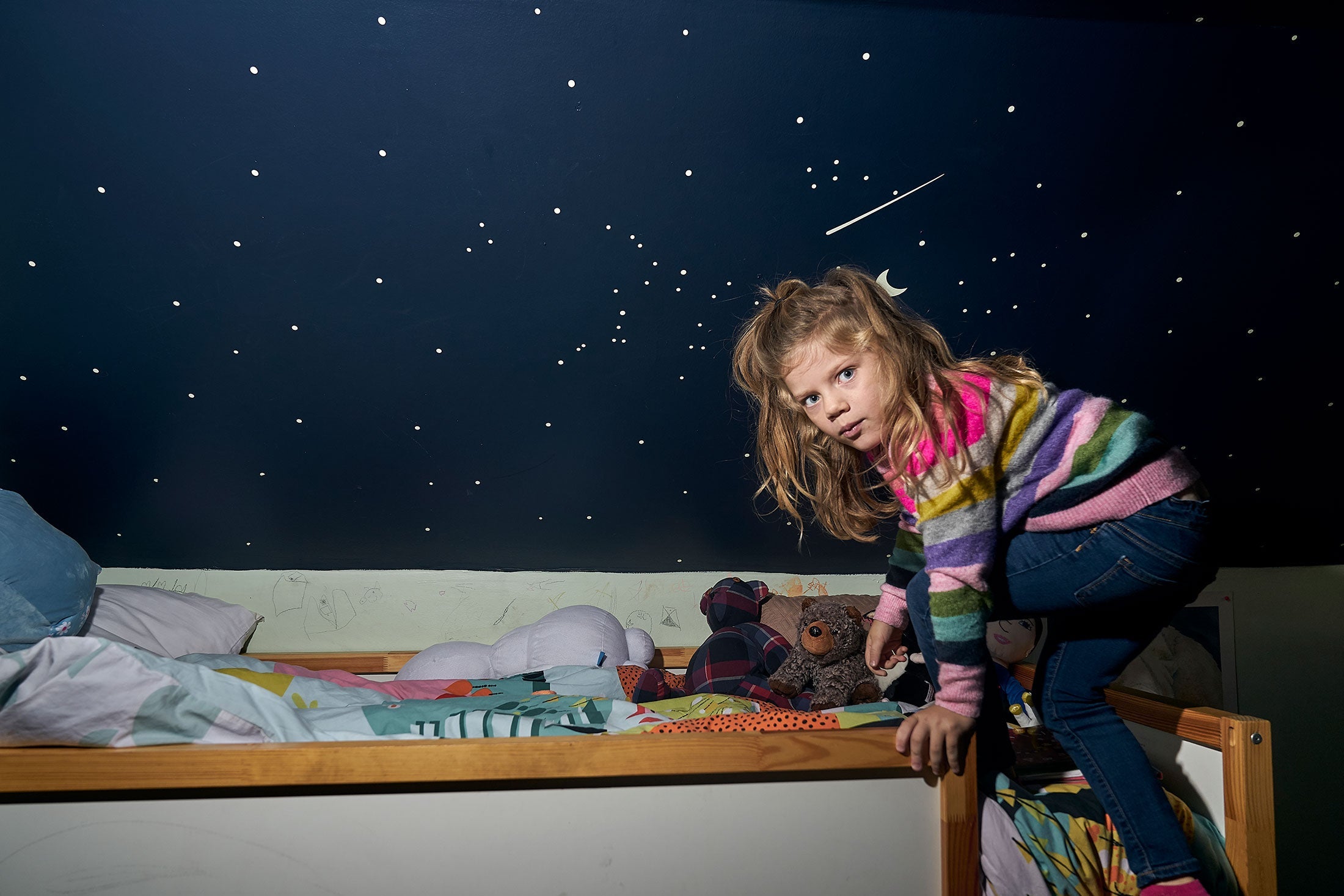 Leah, climbing down from a bunkbed at her home, kindergarten.