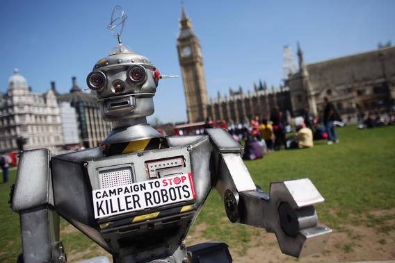 A robot distributes promotional literature calling for a ban on fully autonomous weapons in Parliament Square on April 23, 2013, in London. The Campaign to Stop Killer Robots is calling for a pre-emptive ban on lethal robot weapons that could attack targets without human intervention.