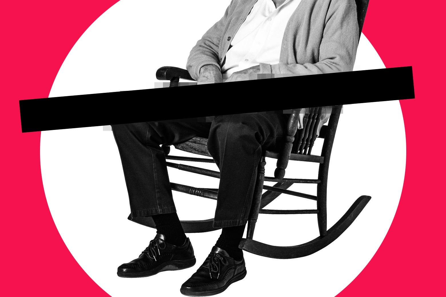 A man sits in a rocking chair. There is a black bar over his lap.