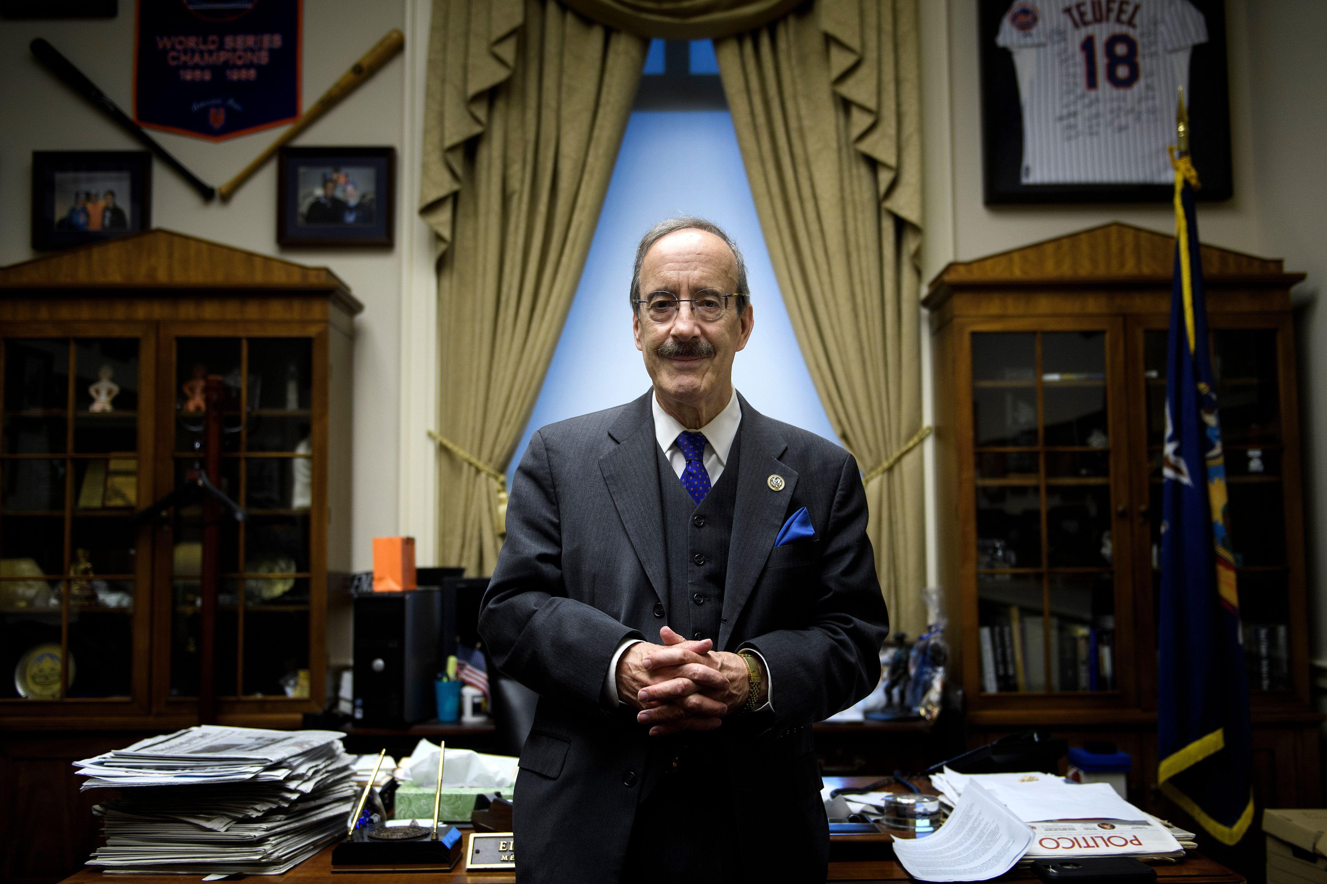 Eliot Engel posing in his office, surrounded by baseball memorabilia. 