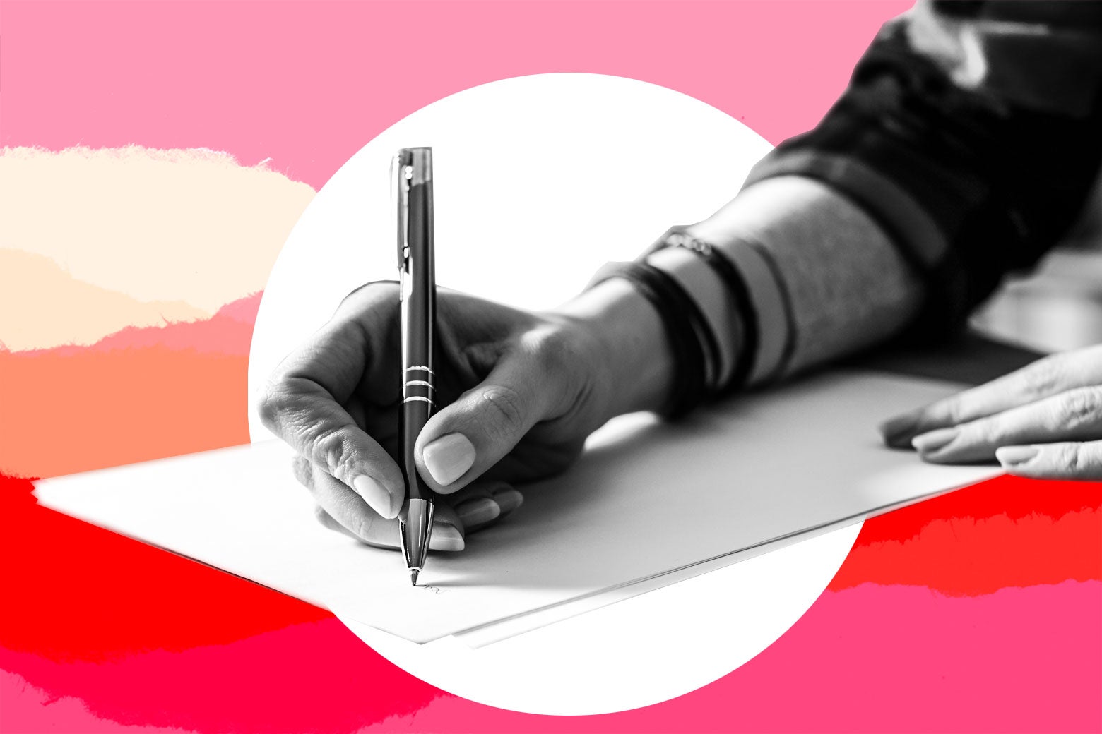 Hand holding a pen, writing a letter.