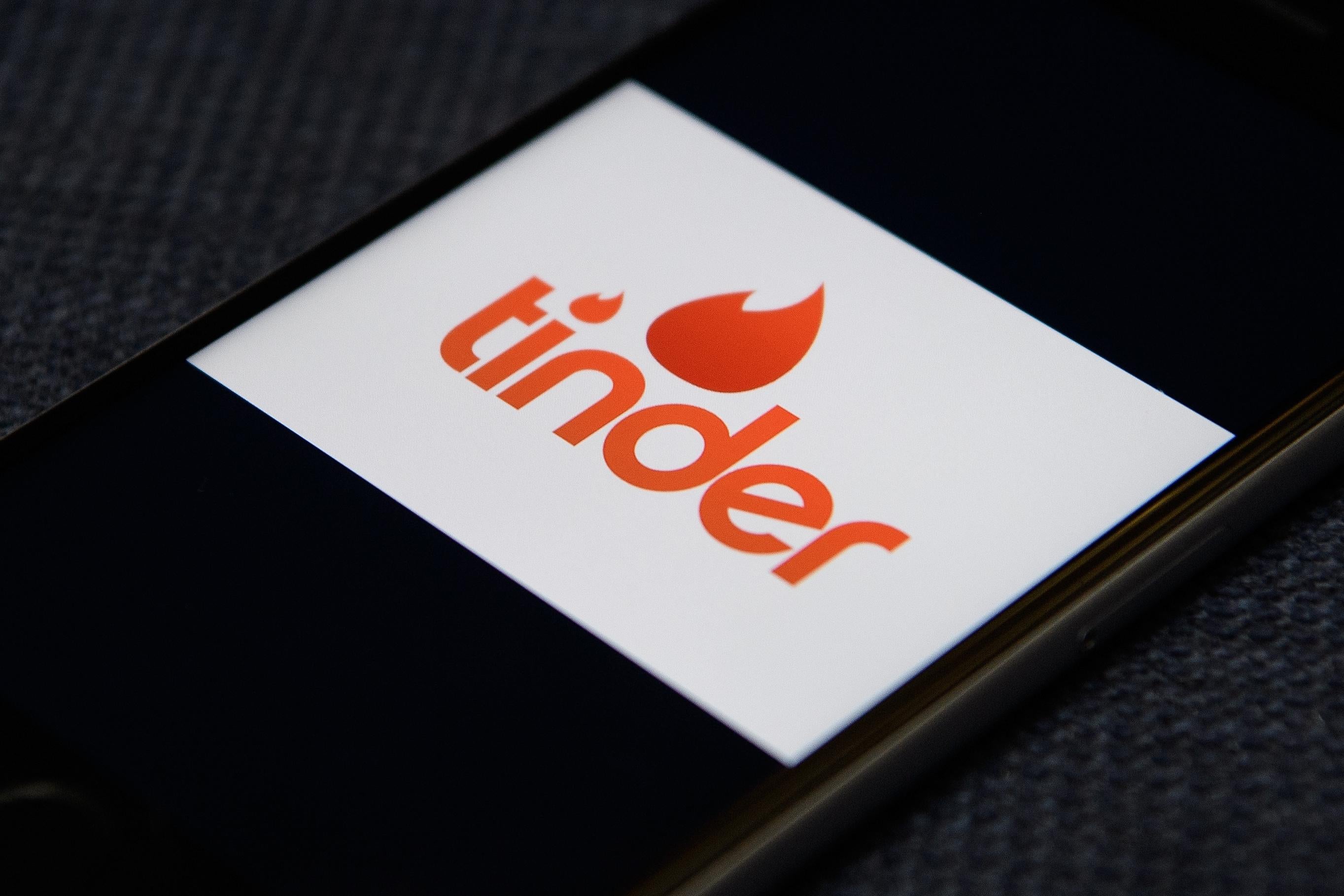 The Tinder app logo is seen on a mobile phone screen.