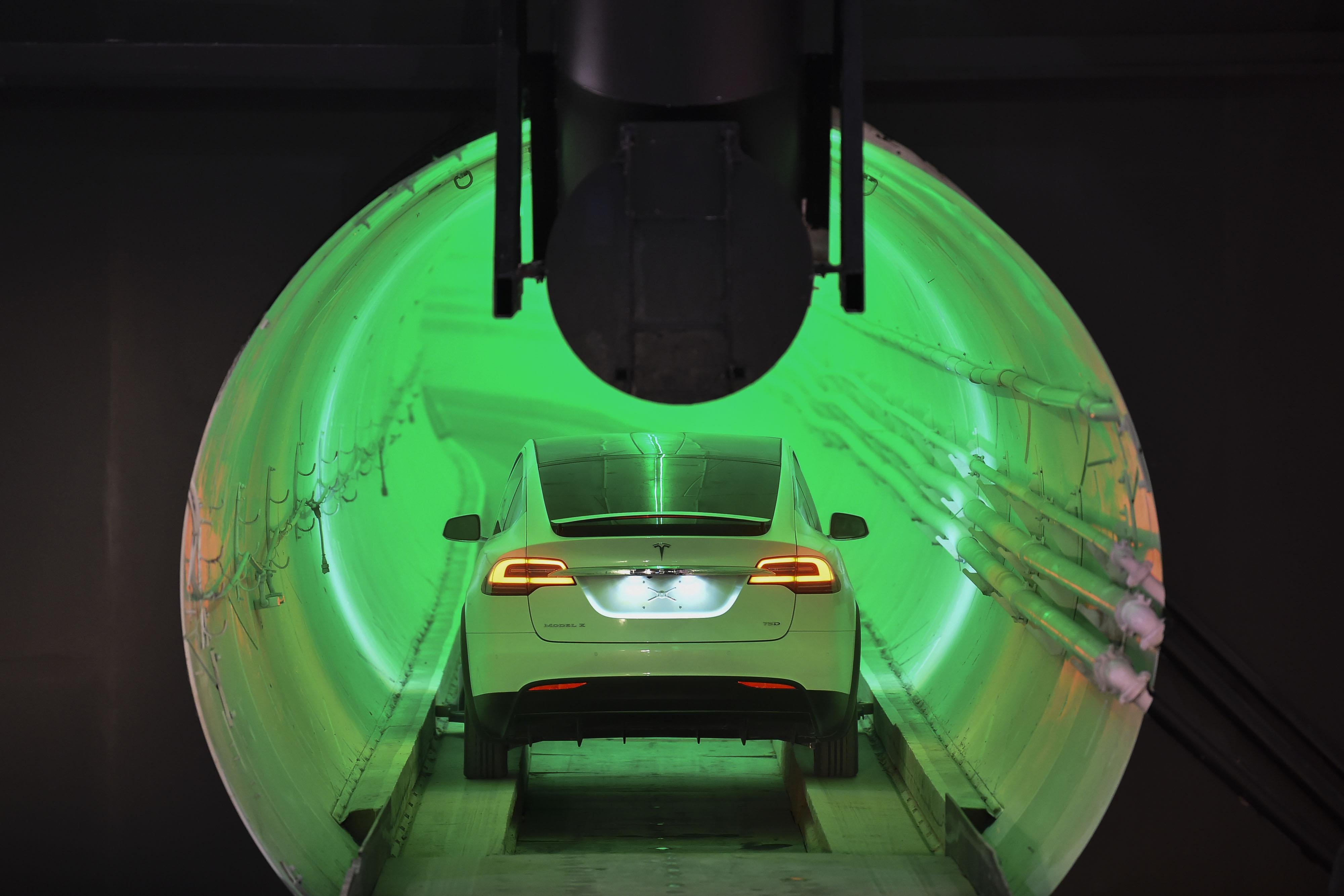 A modified Tesla Model X electric vehicle enters a tunnel.