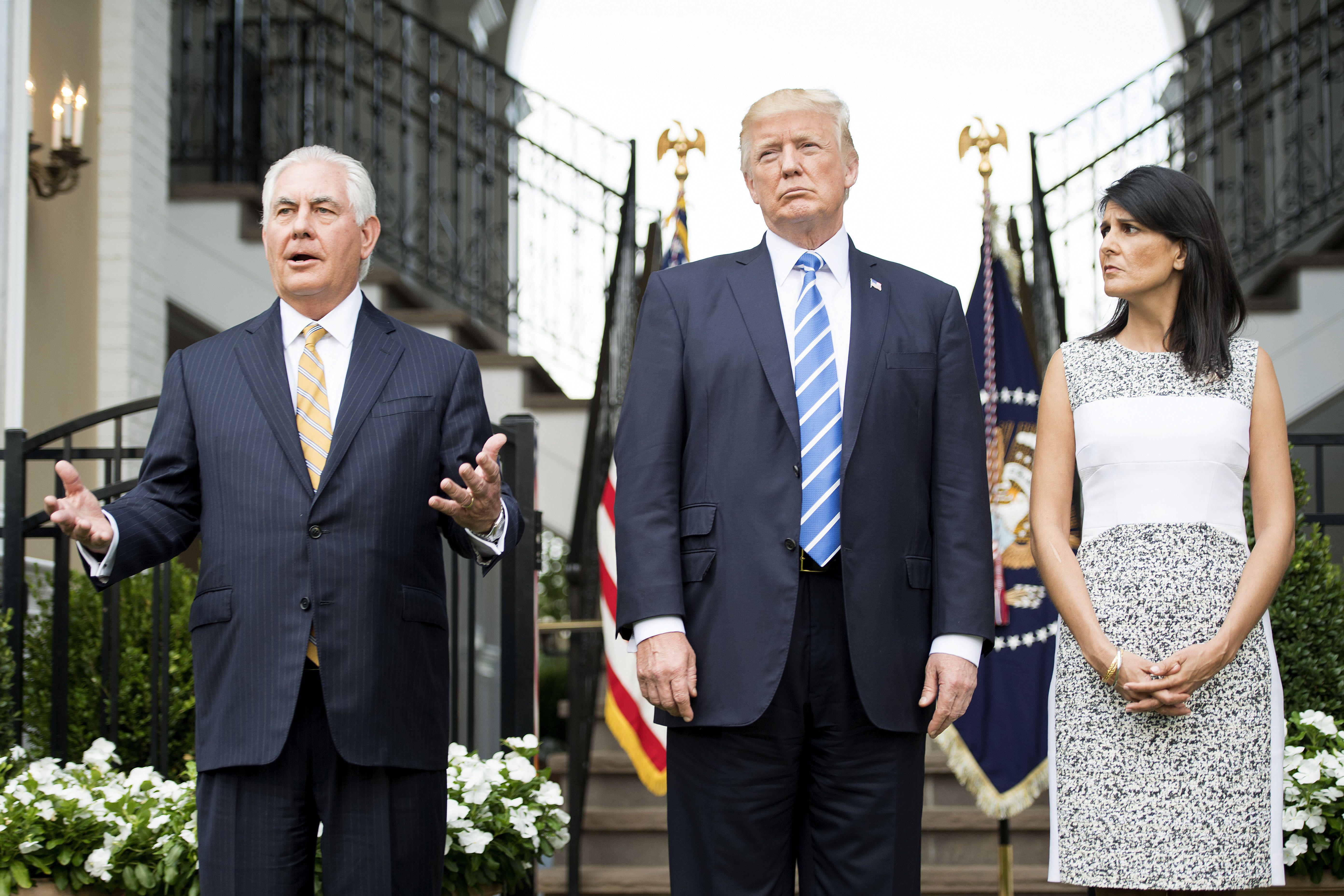 Then-Secretary of State Rex Tillerson (L) speaks to the press with US President Donald Trump (C) and then-U.S. Ambassador to the United Nations Nikki Haley (R) on August 11, 2017, at Trump National Golf Club in Bedminster, New Jersey. 